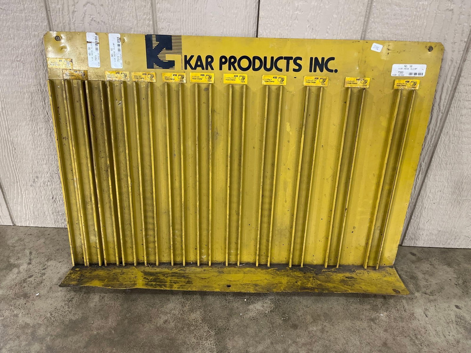 KAR Products Inc. Metal Hose Clamp Organizer Rack: This is a vintage industrial metal hose clamp organizer rack manufactured by KAR Products Inc. The display is constructed of yellow-painted steel and features ten vertical sorting slots. The top