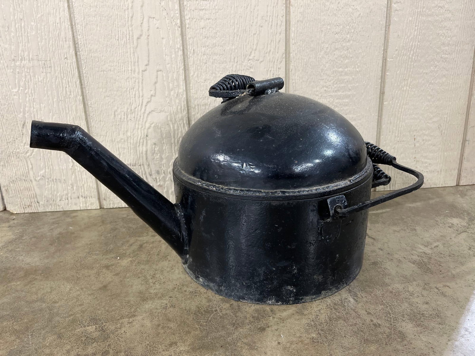 Vtg Railroad Oil Filler Can w/ Coiled Wire Handles: This vintage oil filler can is constructed of heavy-gauge metal and features a cylindrical body with a spherical domed top. It includes two bail handles, one on the top and one on the side, both