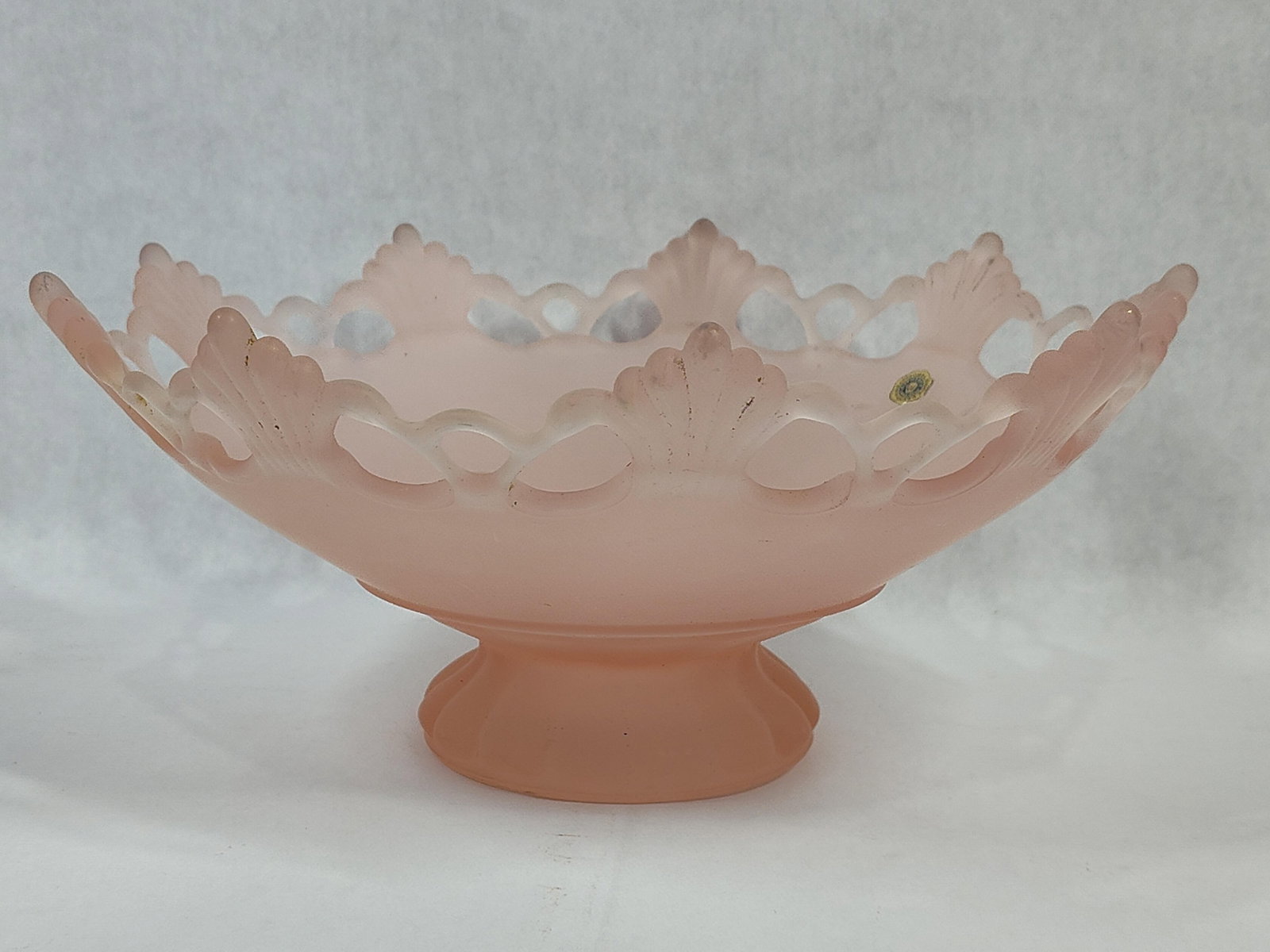 Westmoreland Pink Satin Glass Doric Pedestal Bowl: Westmoreland Glass Company pink satin glass pedestal bowl in the Doric pattern. This footed comport features a wide, shallow bowl with a matte, frosted finish. The rim is decorated with a reticulated