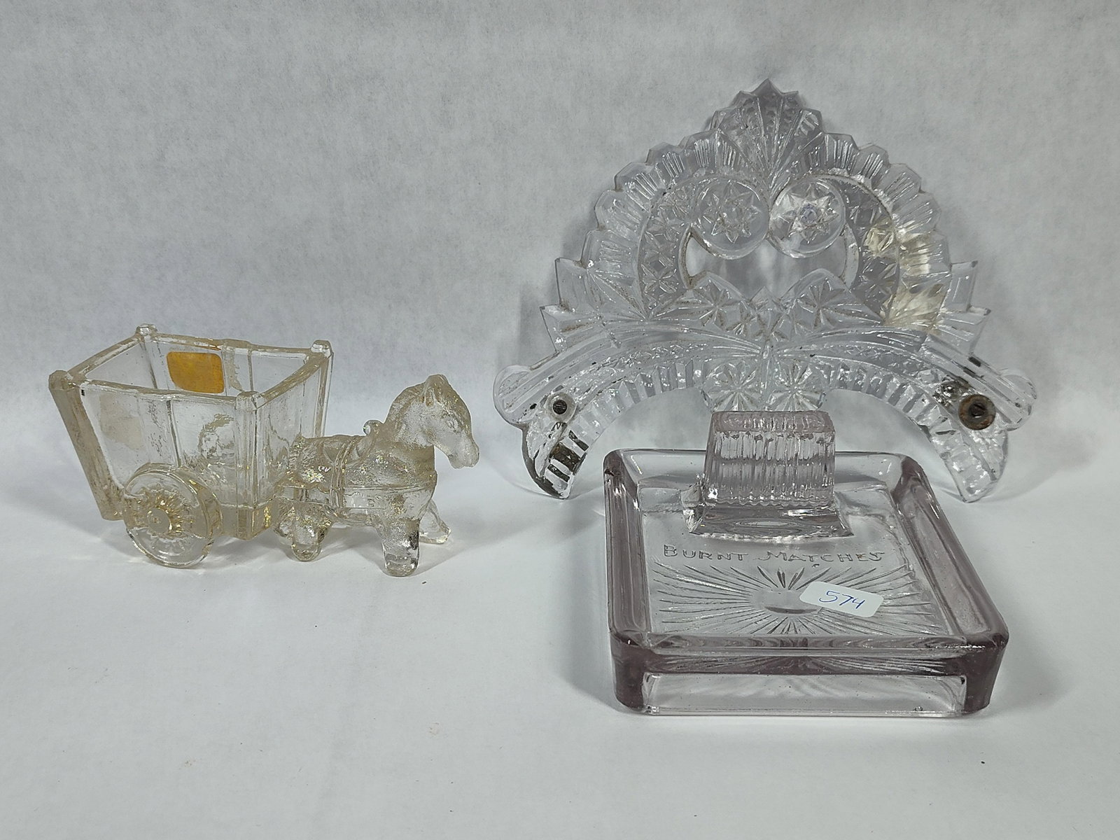 3 Vtg American Pressed Glass Novelties: This lot features three distinct pieces of vintage American pressed glass, likely dating from the late 19th to early 20th century. The first item is a novelty container in the form of a horse-drawn