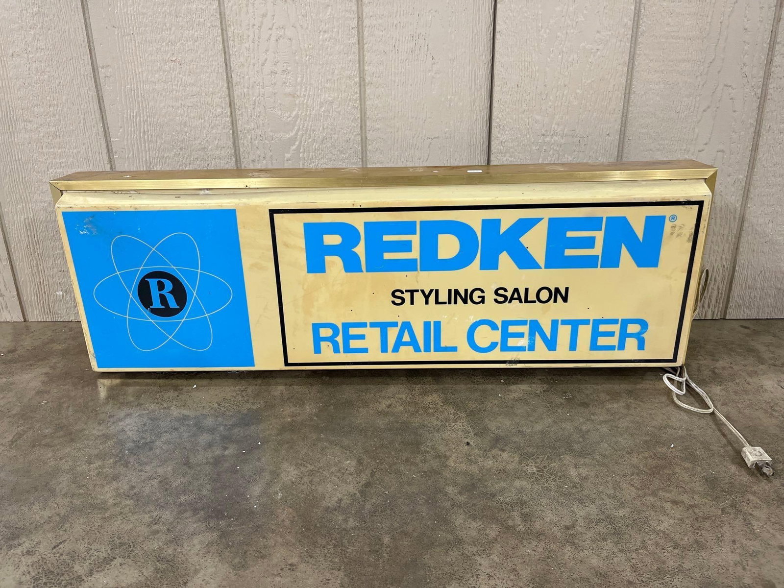 Vtg Redken Styling Salon Illuminated Lightbox Sign: Vintage Redken hair care brand illuminated advertising sign dating to the circa 1970s?1980s era. This rectangular lightbox is constructed with a cream-colored translucent plastic face, likely acrylic 