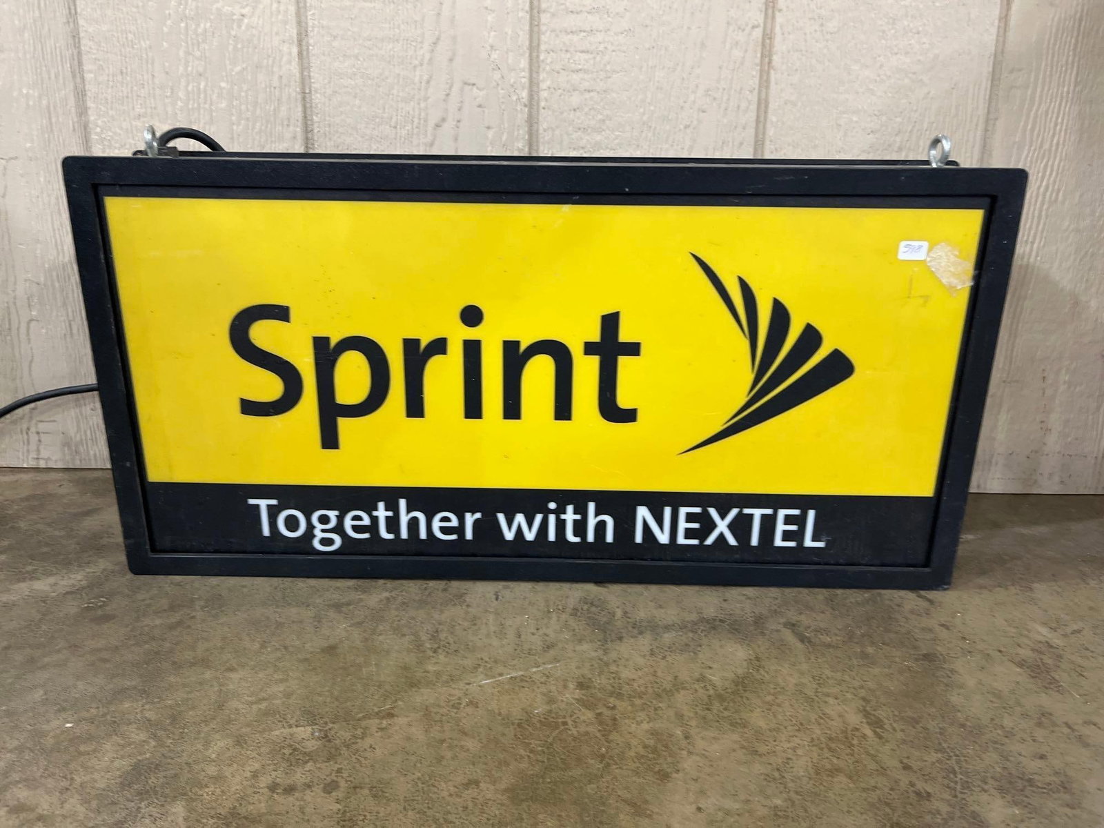 Sprint & Nextel Backlit Electric Advertising Sign: This is an electric backlit retail advertising sign featuring branding from the 2005 merger of Sprint Corporation and Nextel Communications, dating from approximately 2005 to 2013. The rectangular