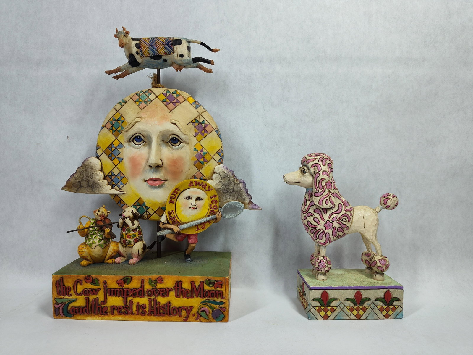 Two Jim Shore Heartwood Creek Resin Figurines: This lot features two hand-painted cast resin figurines from Jim Shore?s Heartwood Creek collection, produced by Enesco. These pieces exhibit the designer?s characteristic folk art style, which