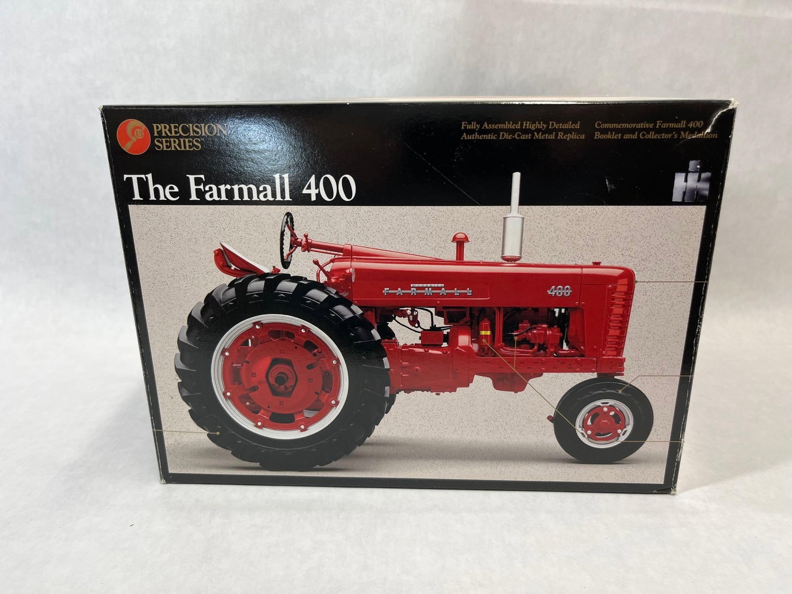 Ertl Precision Farmall 400 Tractor, 1/16: This is a 1/16 scale die-cast metal replica of The Farmall 400 tractor, manufactured by Ertl Collectibles as part of their Precision Series. The model is a highly detailed, fully assembled replica