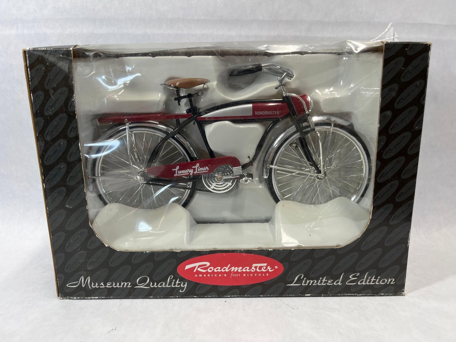 Brunswick Roadmaster Luxury Liner Die-Cast Bicycle: A limited edition 1:6 scale die-cast metal model of a Roadmaster Luxury Liner bicycle, produced by Brunswick. The model features a red and black frame with a baked enamel finish, complemented by