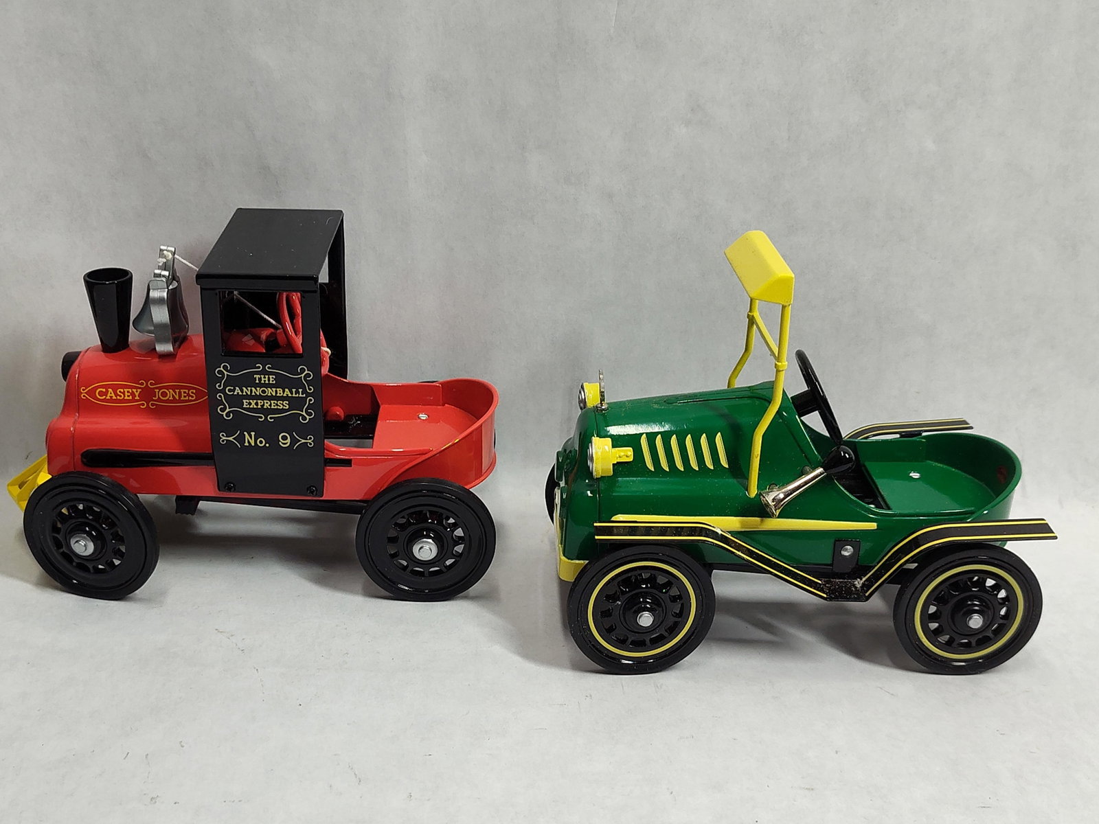 Pair Hallmark Kiddie Cars: Garton Loco & Tin: This lot features two miniature collectible vehicles from the Hallmark Kiddie Car Classics series, which are scale replicas of original pedal cars produced by the Garton Toy Co. The first vehicle is
