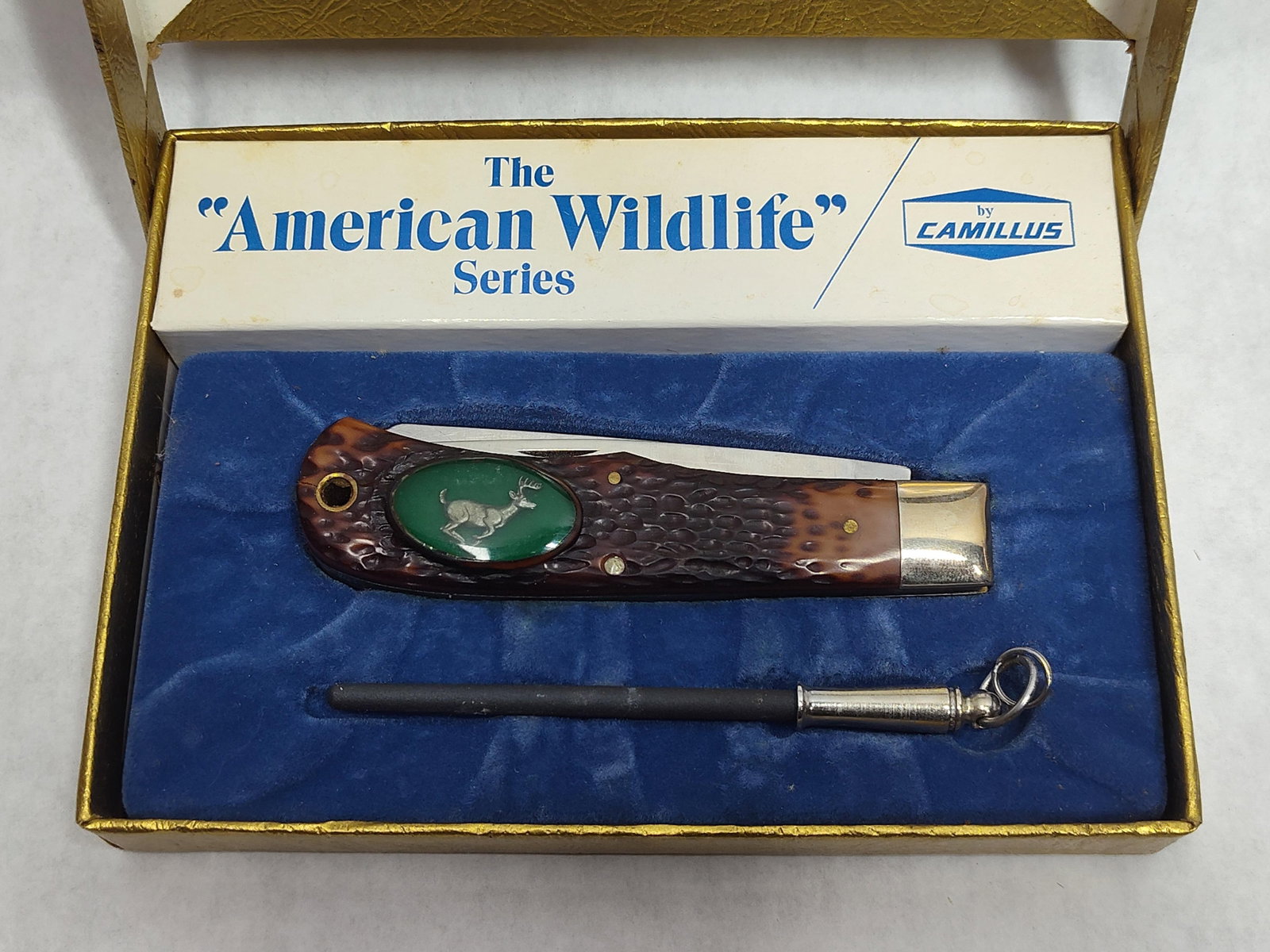 Camillus No. 10C Running Deer Pocket Knife Set: A Camillus American Wildlife Series lockback pocket knife, model No. 10C Running Deer. The knife features a single blade and brown jigged synthetic handles accented with a silver-tone running deer