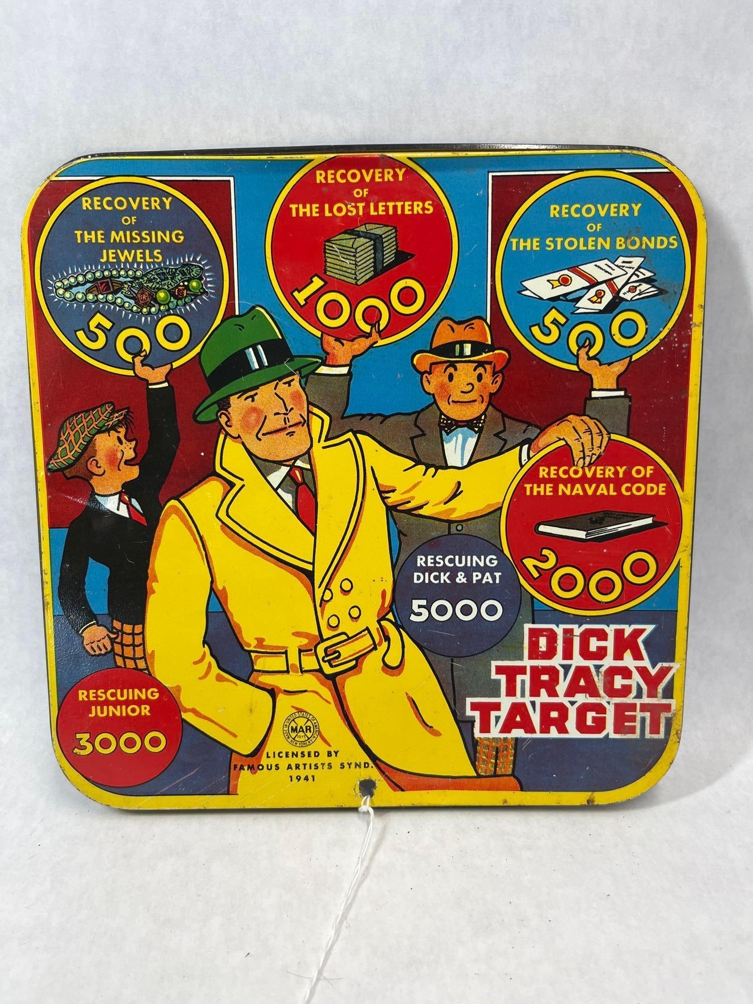 Louis Marx and Co. Dick Tracy Target Game, 1941: A double-sided lithographed tin target board produced by Louis Marx and Co. The square-shaped board features multi-colored graphics on both sides. The front side depicts characters from the Dick