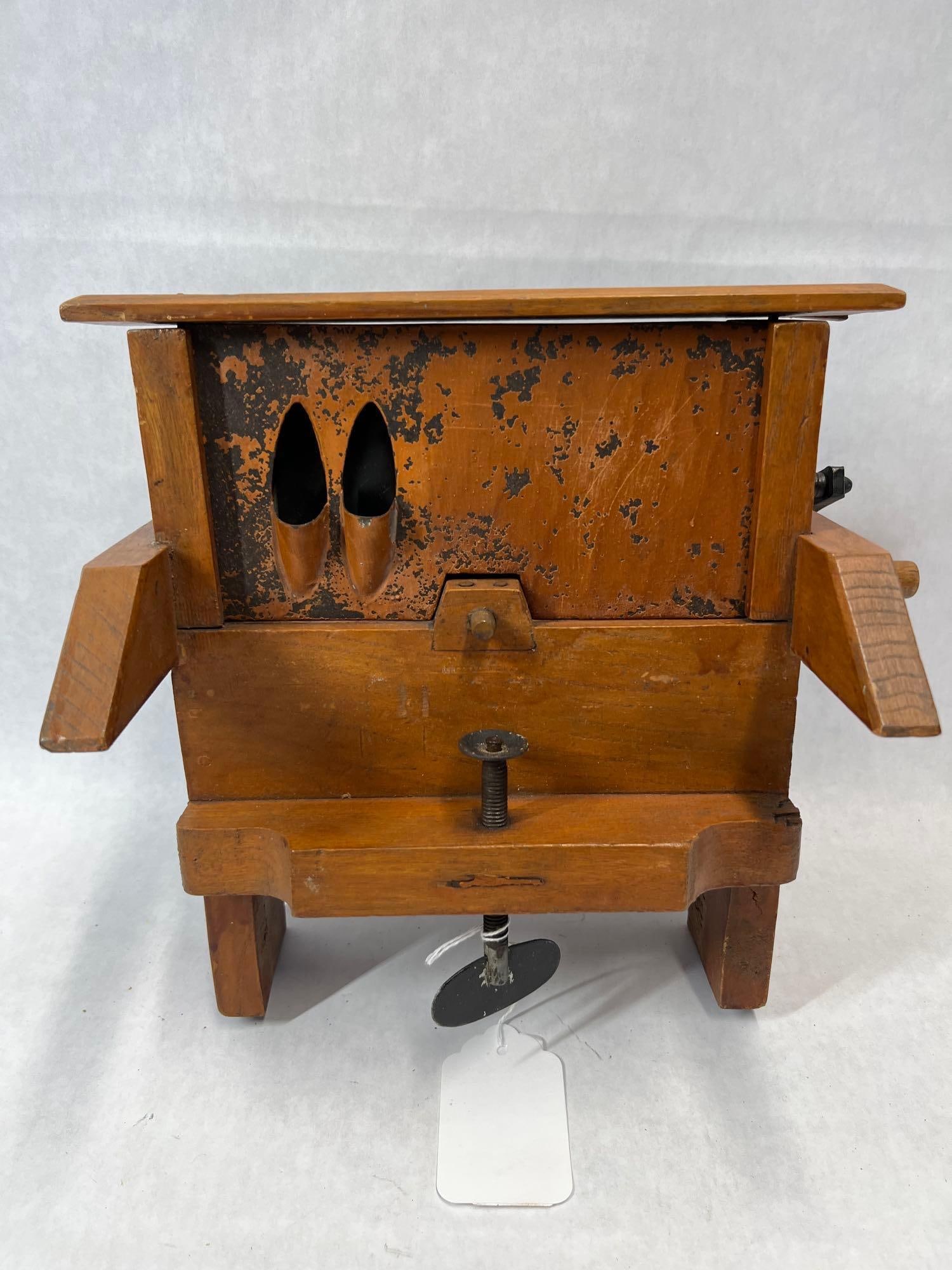 Antique Hand-Crank Double Bean Slicer: This antique kitchen implement is a double bean slicer, a tool historically used for processing green beans into thin strips, often found in Dutch and German households. The device features a wooden b