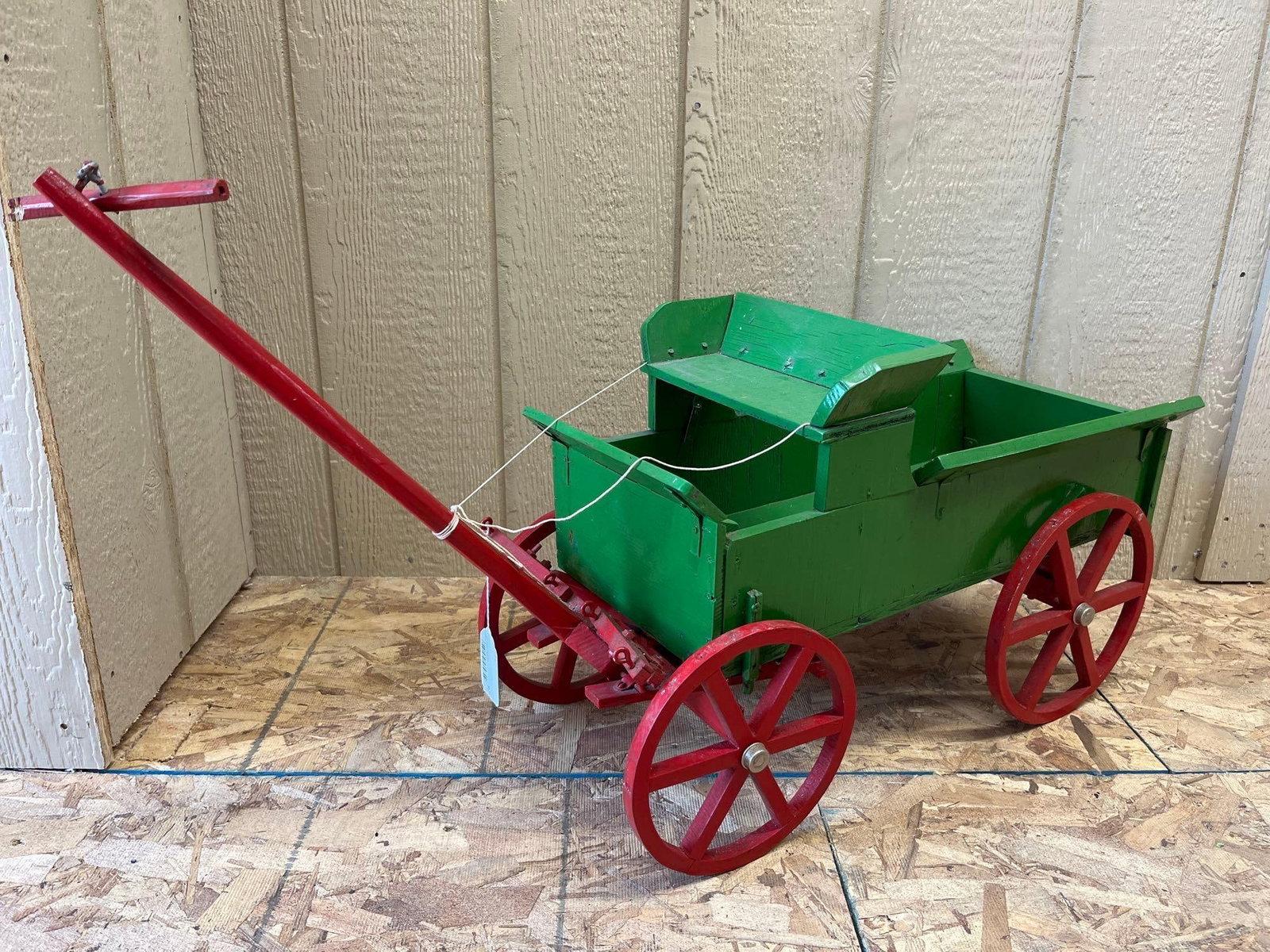 Wooden Junior Goat Style Farm Wagon: This large-scale pull wagon is constructed in the tradition of a nineteenth-century farm or spring wagon, frequently referred to as a goat wagon or junior wagon. The piece is handcrafted primarily