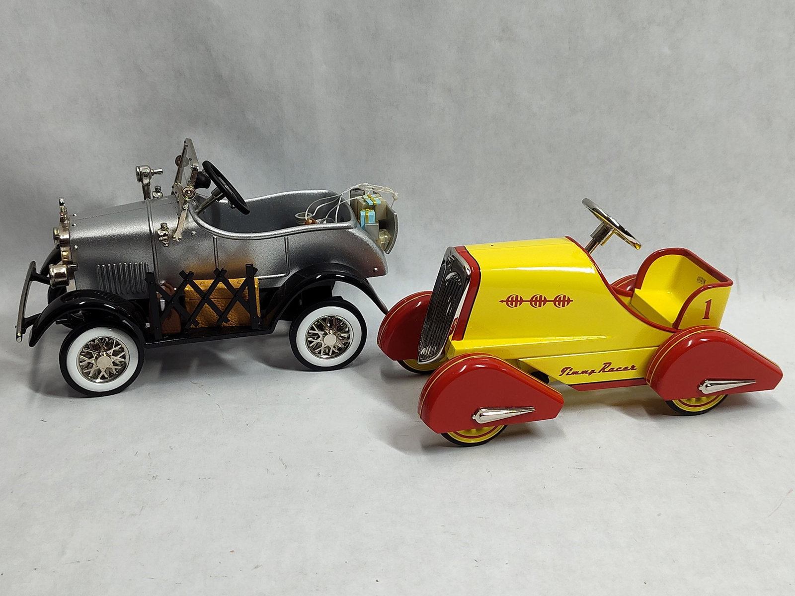 Two Hallmark Kiddie Car Classics Model Vehicles: This lot consists of two collectible model vehicles from the Hallmark Kiddie Car Classics series, which are replicas of cars and pedal cars intended for collectors. The first model is a roadster