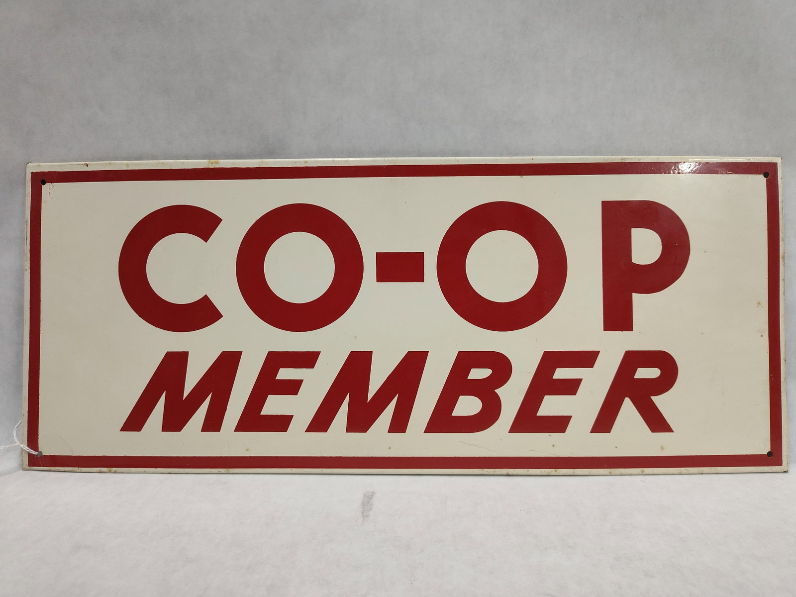 Co-op Member Single-Sided Metal Sign: A single-sided member identification sign produced for agricultural and consumer cooperatives, typically dating from the mid-20th century. The sign is constructed of finished metal, likely porcelain