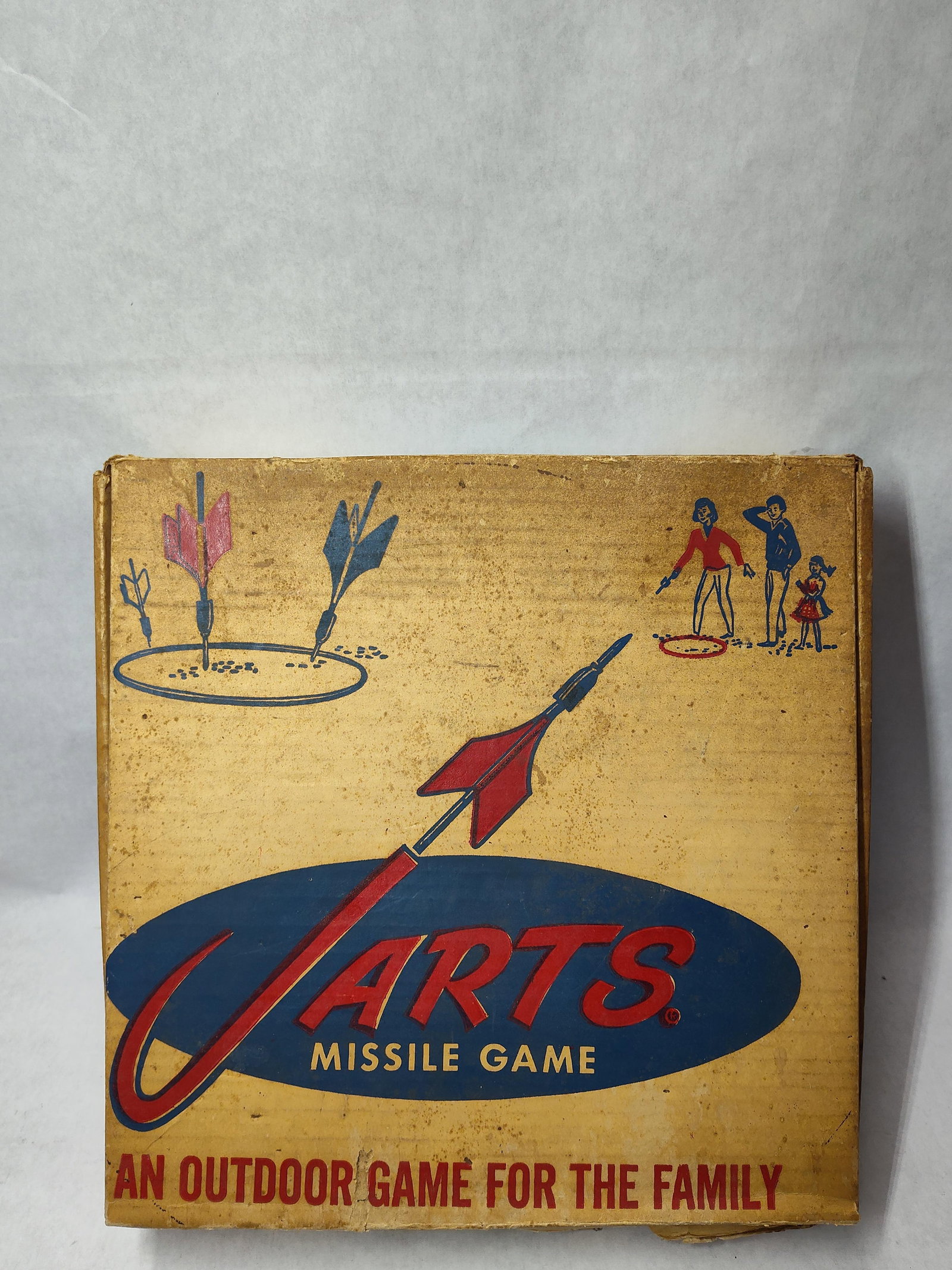 Jarts Missile Game Set in Original Box: A Jarts Missile Game set, an outdoor lawn game, housed in its original illustrated cardboard box. The set features an assortment of heavy metal darts with weighted tips and three-point plastic fins