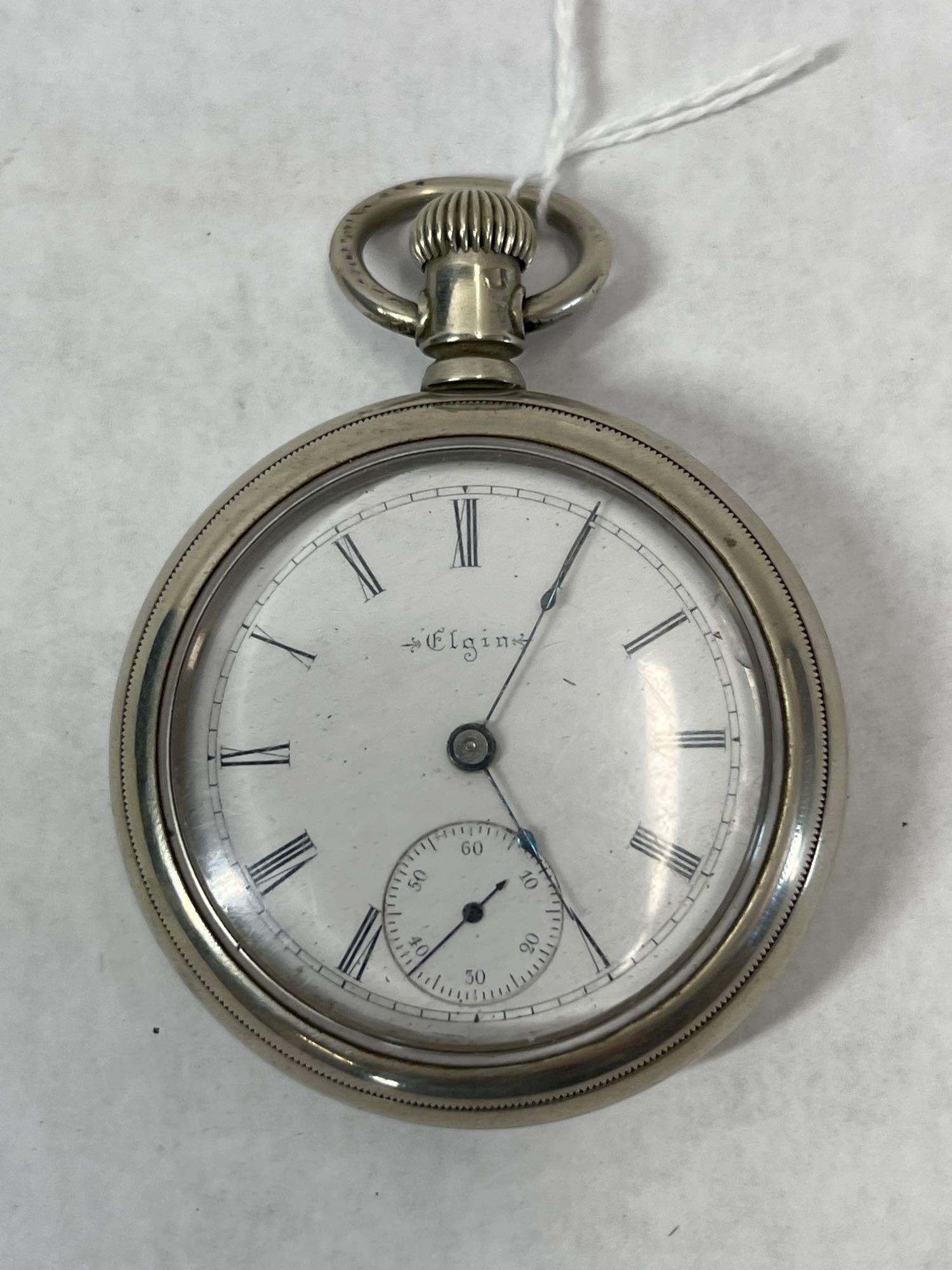 Elgin G.M. Wheeler Grade 73 Open Face Pocket Watch: This is an antique open-face pocket watch manufactured by the Elgin National Watch Company. The mechanical movement is a G.M. Wheeler grade (Grade 73), serial number 5521844, dating the piece to