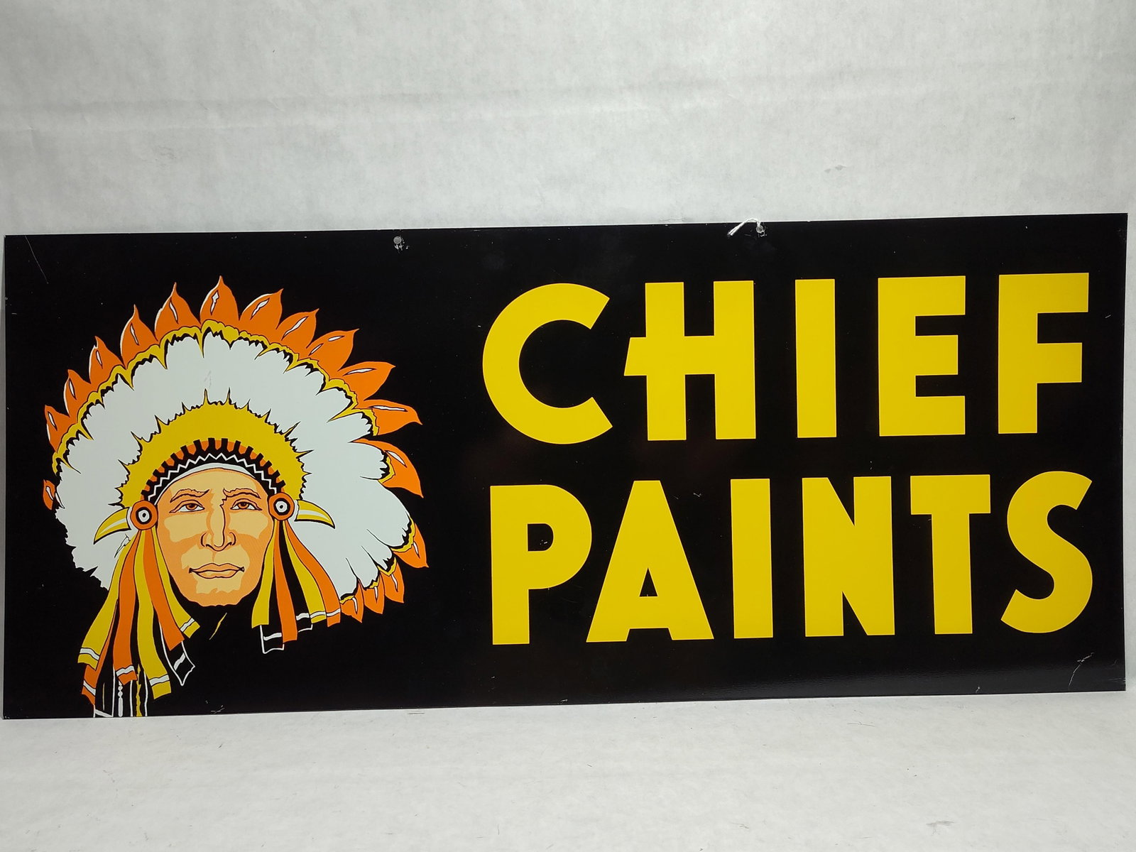 Chief Paints Double-Sided Metal Advertising Sign: A metal advertising sign for Chief Paints, a brand historically associated with the Chicago Paint Works. The sign features a rectangular form with a high-gloss black background. The left side of the
