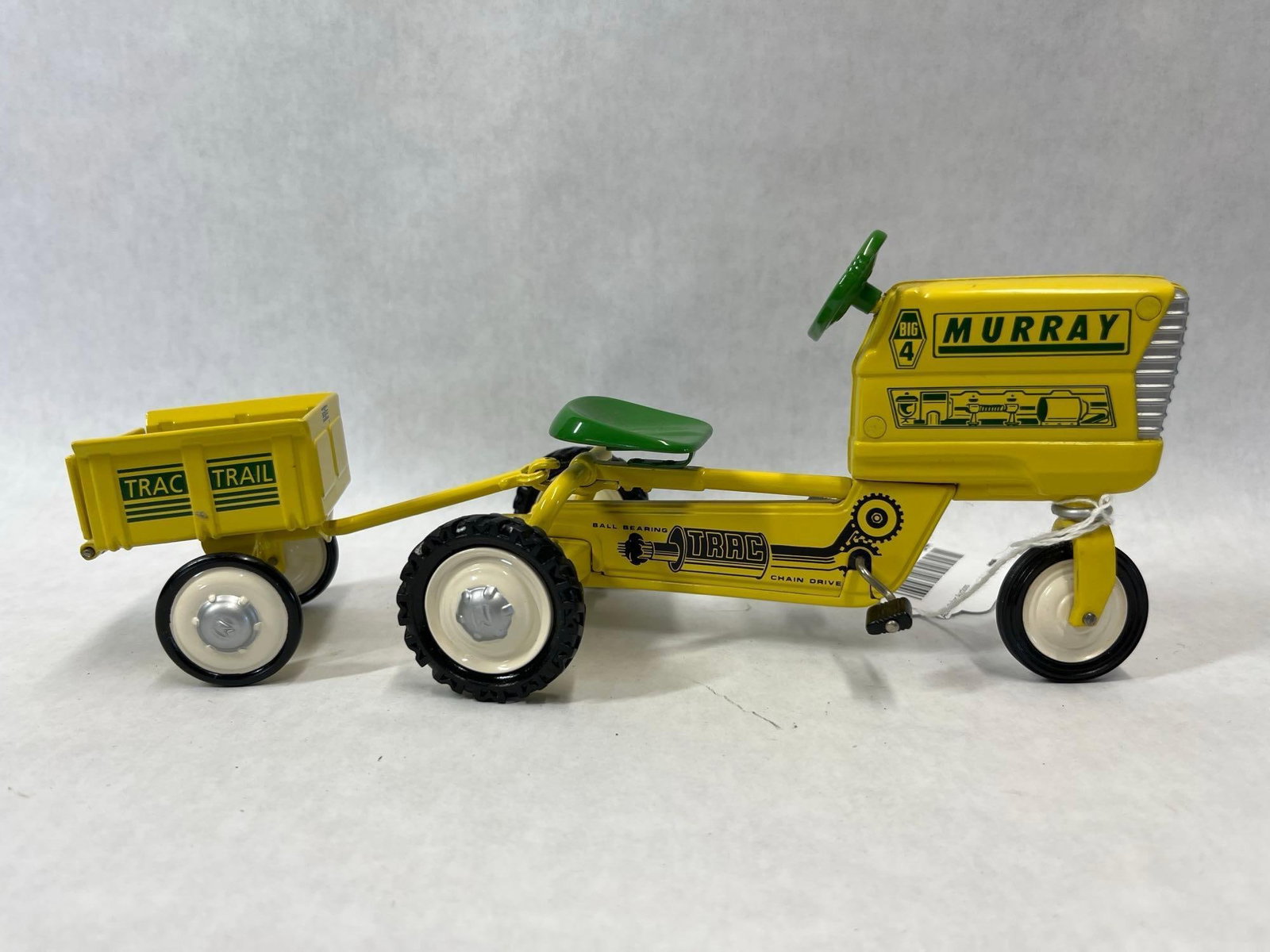 Hallmark 1961 Murray Pedal Tractor w/ Trailer: A precision scale model replica of a 1961 Murray Big 4 pedal tractor and matching trailer from the Hallmark Kiddie Car Classics collection. This set features a tractor and a detachable two-wheeled