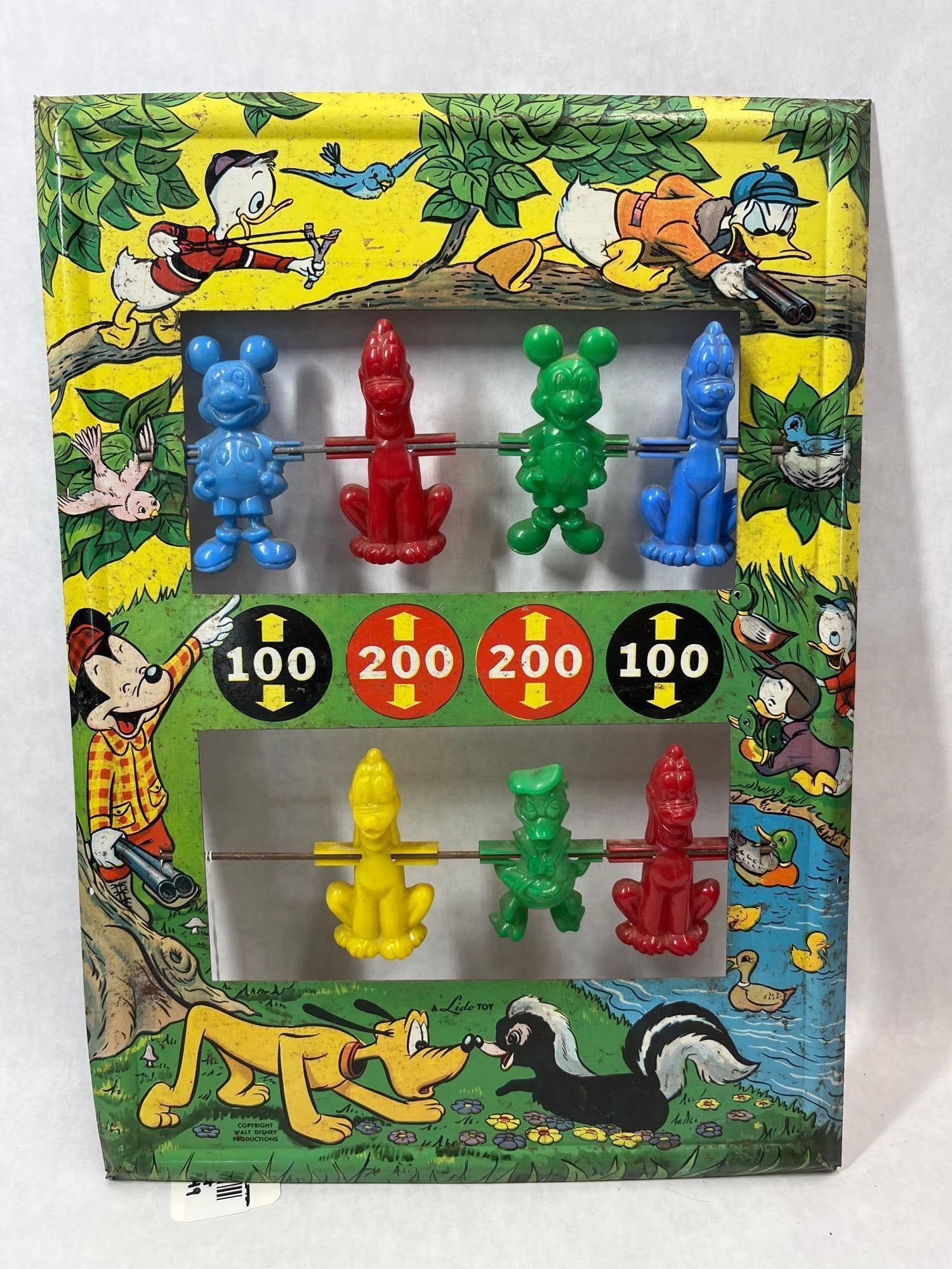 Lido Toy Walt Disney Tin Target Shooting Gallery: This target gallery toy was manufactured by Lido Toy under license from Walt Disney Productions. The item features a rectangular lithographed tin frame decorated with multi-colored graphics of