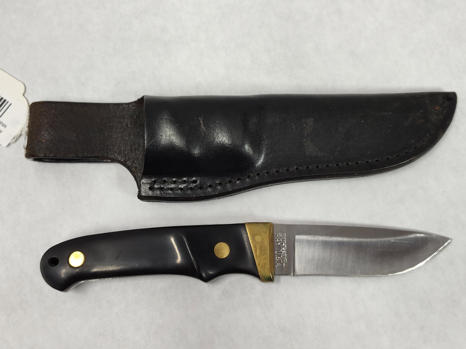 Schrade USA PH1 Professional Hunter Knife & Sheath: This Schrade PH1 Professional Hunter is a fixed-blade hunting knife manufactured in the United States. The stainless steel blade features a drop-point design with a satin finish. The tang is stamped o