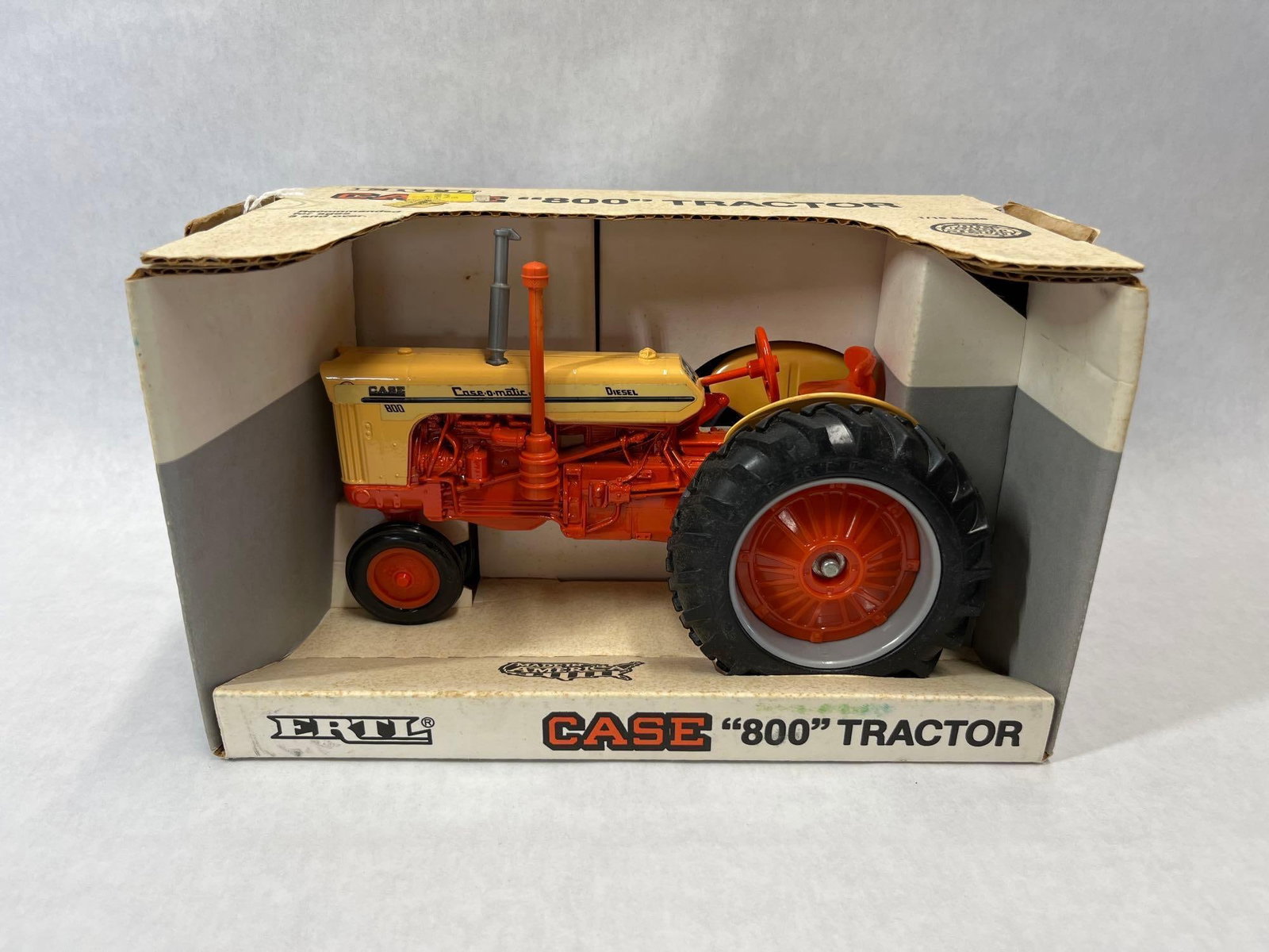 Ertl Case 800 Case-o-matic Diesel Tractor w/ Box: Manufactured by Ertl, this 1/16 scale model represents a Case 800 Case-o-matic Diesel tractor. The model is constructed from die-cast metal and features a steerable wide front axle, rubber tires, and 