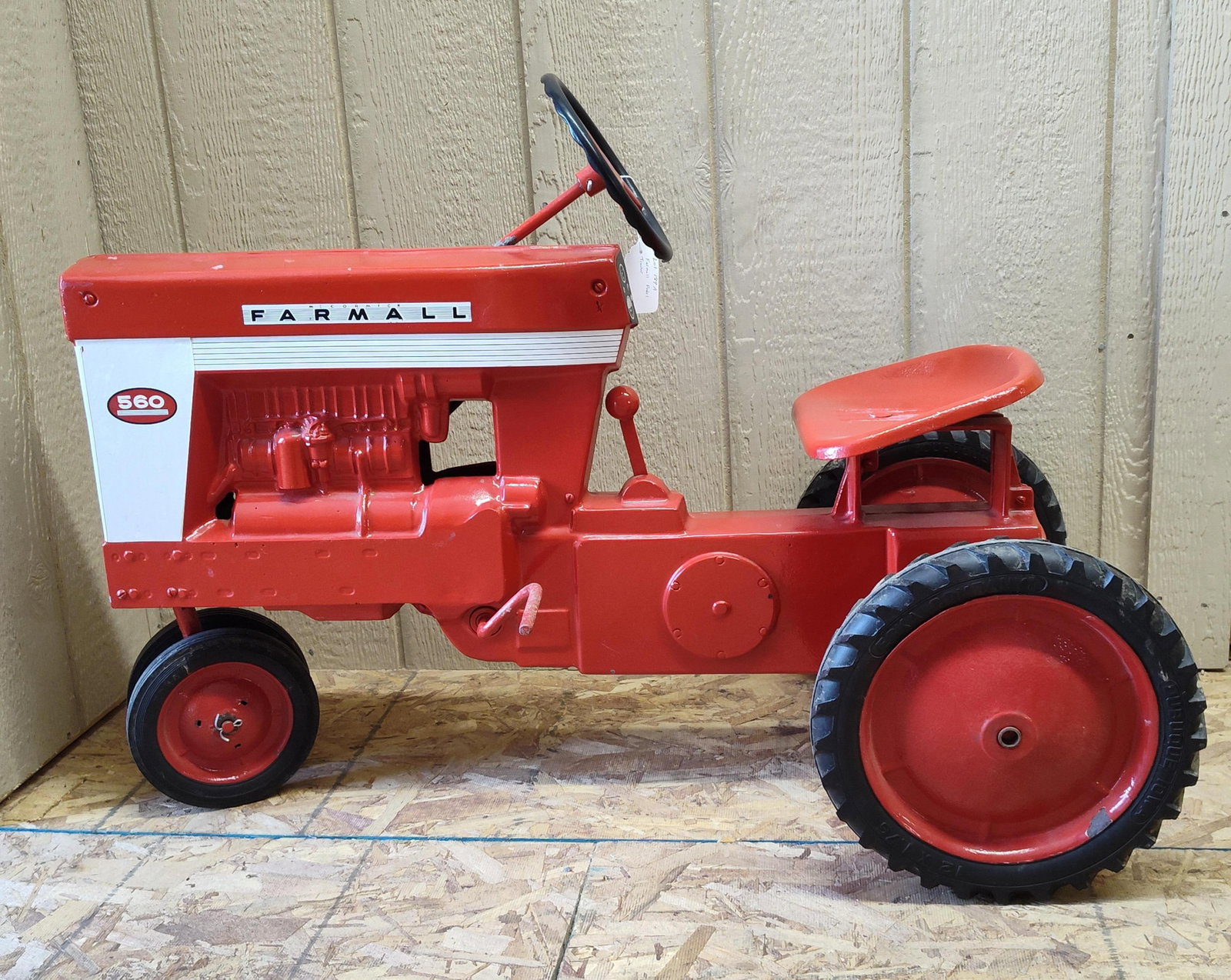 Eska Farmall 560 Tractorcycle Pedal Tractor: This pedal tractor is manufactured by the Eska Company of Dubuque, Iowa, and is a scaled representation of the International Harvester Farmall 560 tractor. The toy features a two-piece sand-cast alumi