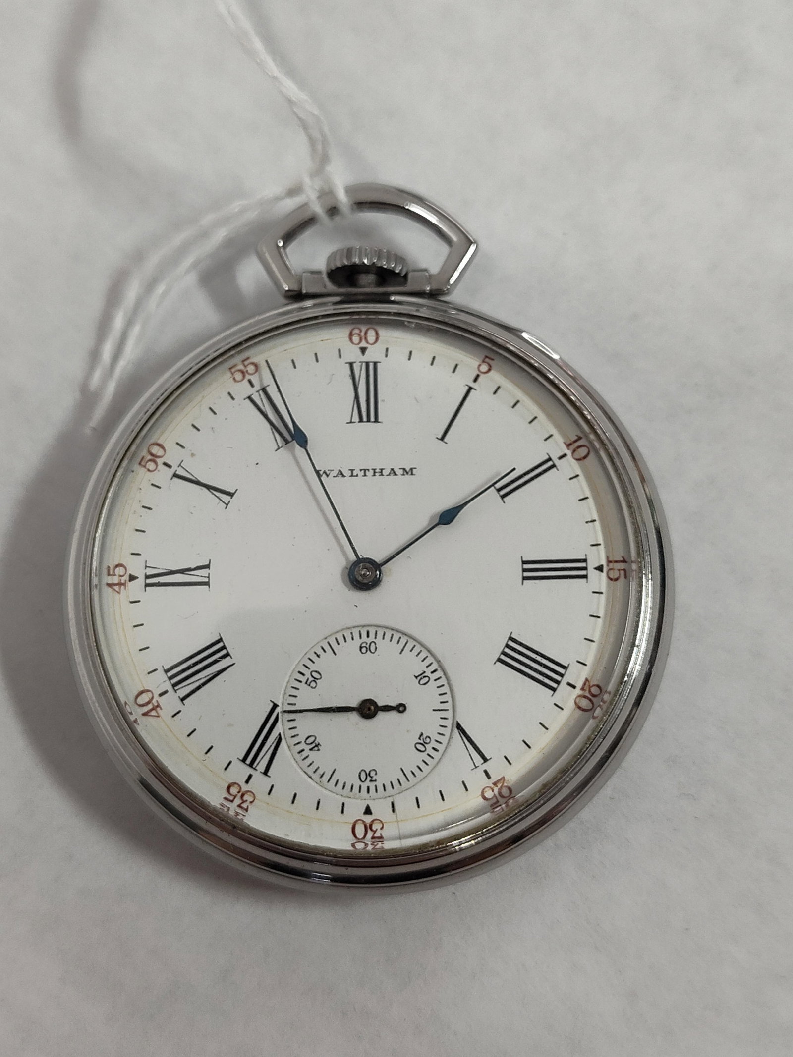 Waltham Open Face Pocket Watch, Silver Tone Case: Waltham open face pocket watch featuring a white dial with black Roman numeral hour markers and a secondary outer minute track with red Arabic numerals at five-minute intervals from 5 to 60. The dial 