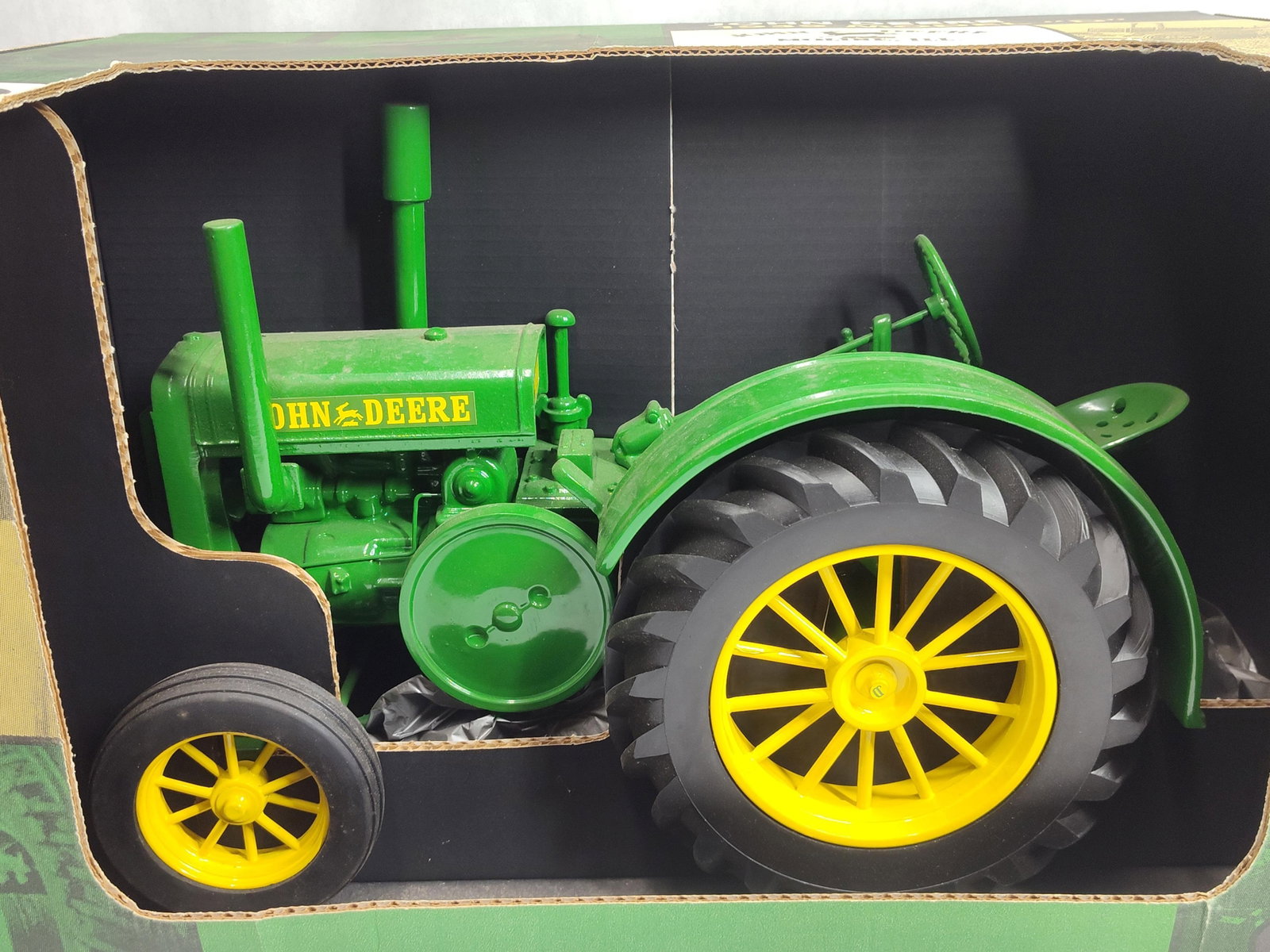 Scale Models John Deere Model D Sandcast Tractor: A large 1/8 scale collectible replica of a John Deere 1939 Model D tractor manufactured by Scale Models. The piece features a highly detailed sandcast metal body and engine finished in signature John