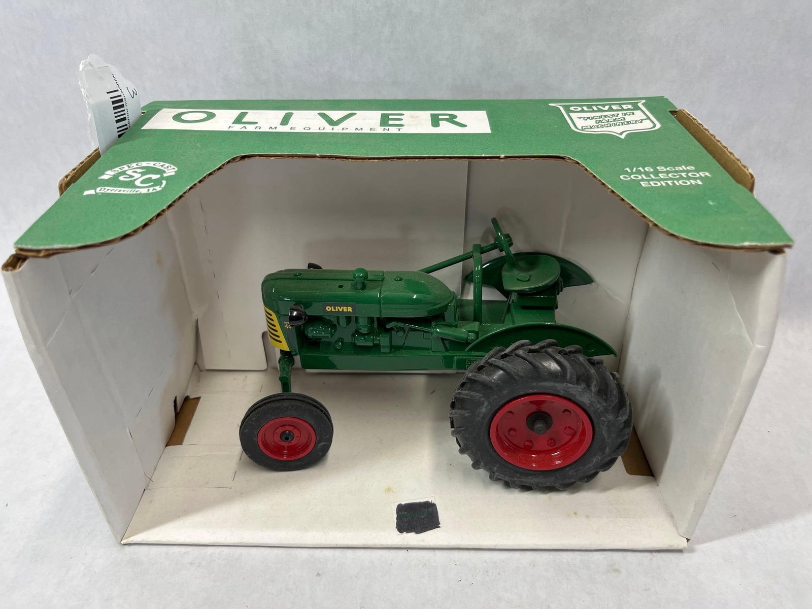 SpecCast 1/16 Oliver Super 44 Wide Front Tractor: This 1/16 scale model depicts an Oliver Super 44 tractor, manufactured by Spec-Cast of Dyersville, Iowa. The model is constructed of die-cast metal for the body and rims with rubber tires. It is