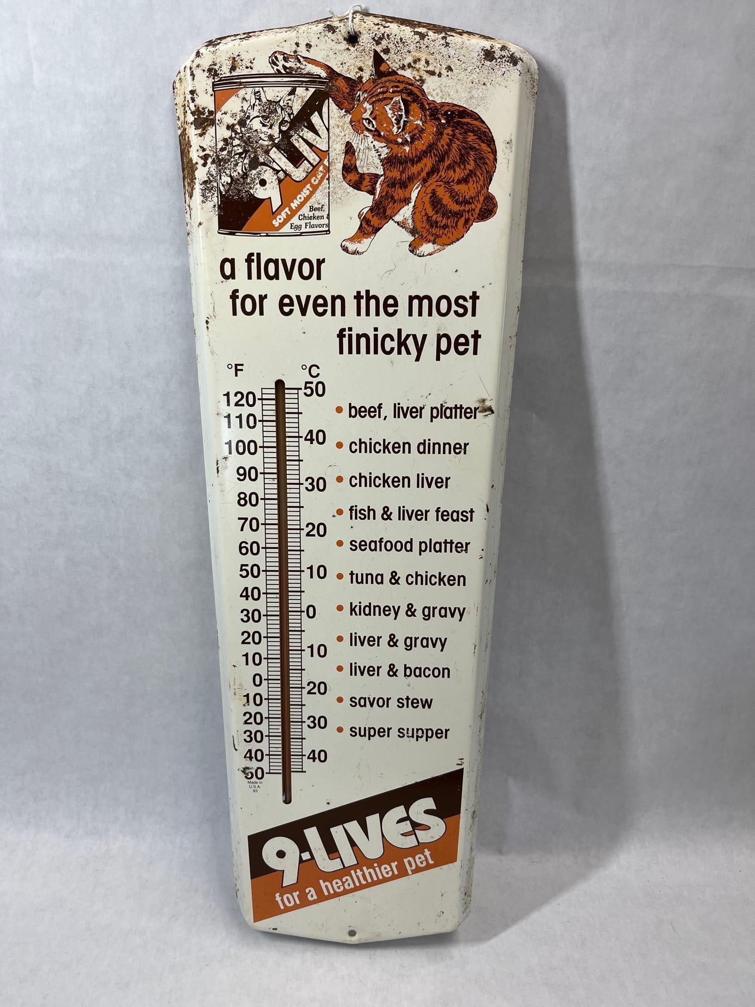 9-Lives Cat Food Lithographed Metal Thermometer: A lithographed metal advertising wall thermometer produced for 9-Lives cat food. The thermometer features a tapered pillar shape with a white ground and multi-color graphics. The top portion displays