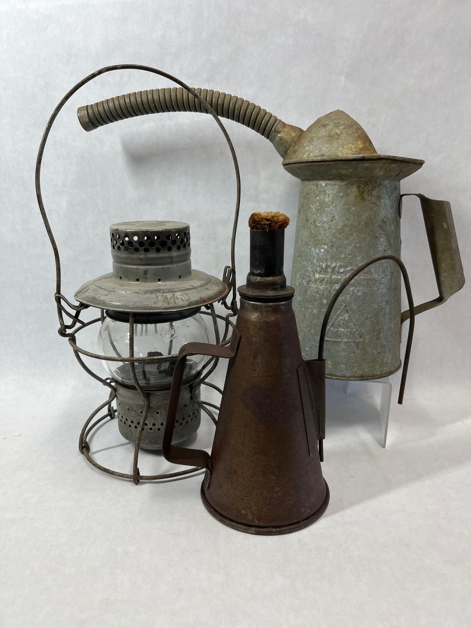 Handlan Lantern, Johnson Torch & PRR Metal Set: This lot features three antique industrial metal objects associated with the early to mid-20th-century railroad industry. The first item is a short-globe railroad lantern manufactured by Handlan of St