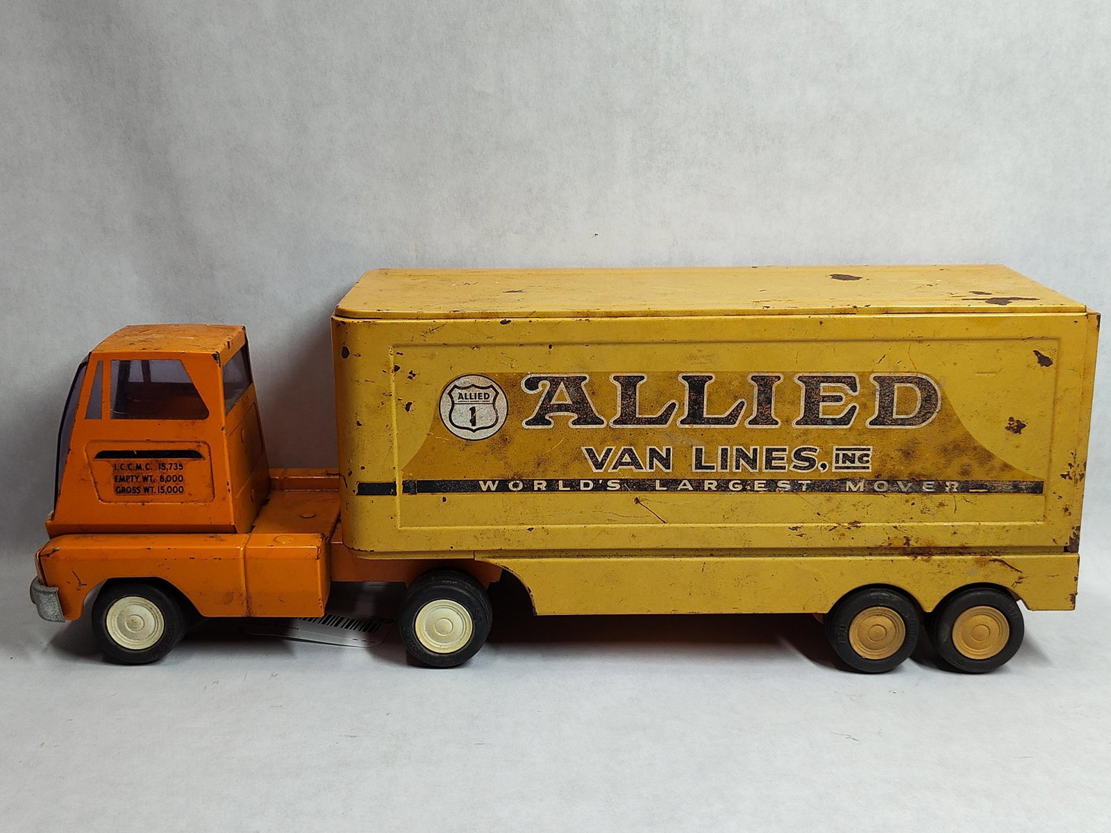 Tonka Allied Van Lines Tractor Trailer Set c.1960s: A Tonka tractor trailer set featuring Allied Van Lines livery, manufactured circa the 1960s. The toy is constructed of pressed steel and includes a Cab-Over-Engine (COE) tractor in orange and a