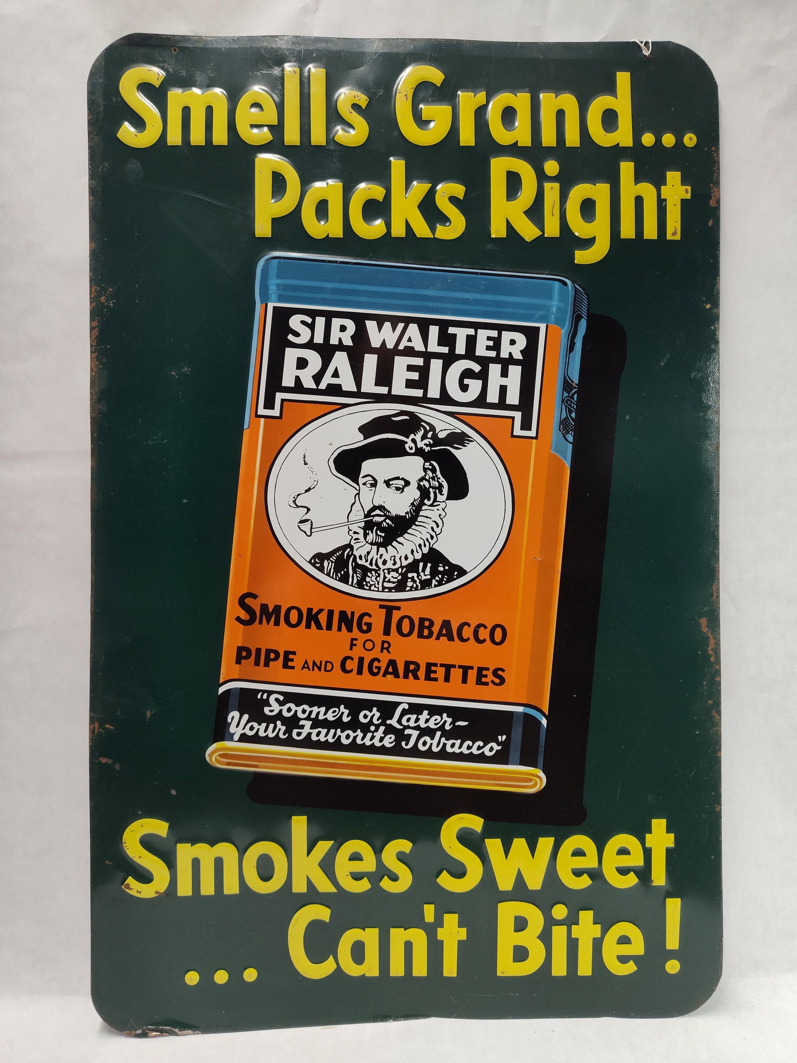 Sir Walter Raleigh Tobacco Embossed Metal Sign: A mid-20th century embossed metal advertising sign for Sir Walter Raleigh Smoking Tobacco, produced for the Brown and Williamson Tobacco Corporation. The sign is constructed of lithographed sheet