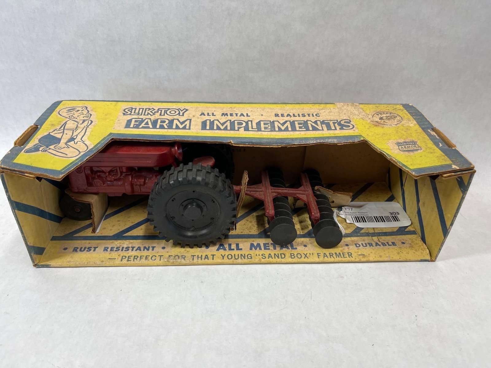 Slik-Toy Tractor & Disc Set in Original Box: This set is manufactured by Slik-Toy, a division of Armor Industries located in Lansing, Iowa. The set features a die-cast metal tractor and a matching die-cast metal disc harrow implement. The tracto
