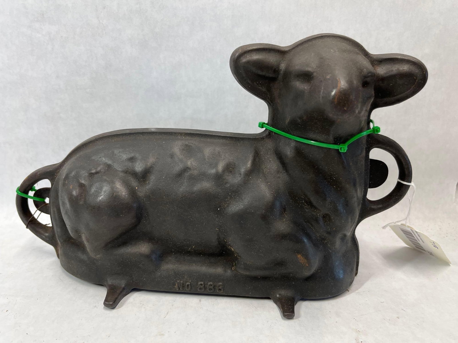 Griswold Cast Iron Lamb Cake Mold No. 866: This is a two-piece cast iron cake mold produced by Griswold, designed in the form of a reclining lamb. The mold consists of two interlocking sections used for baking three-dimensional cakes, a tradit