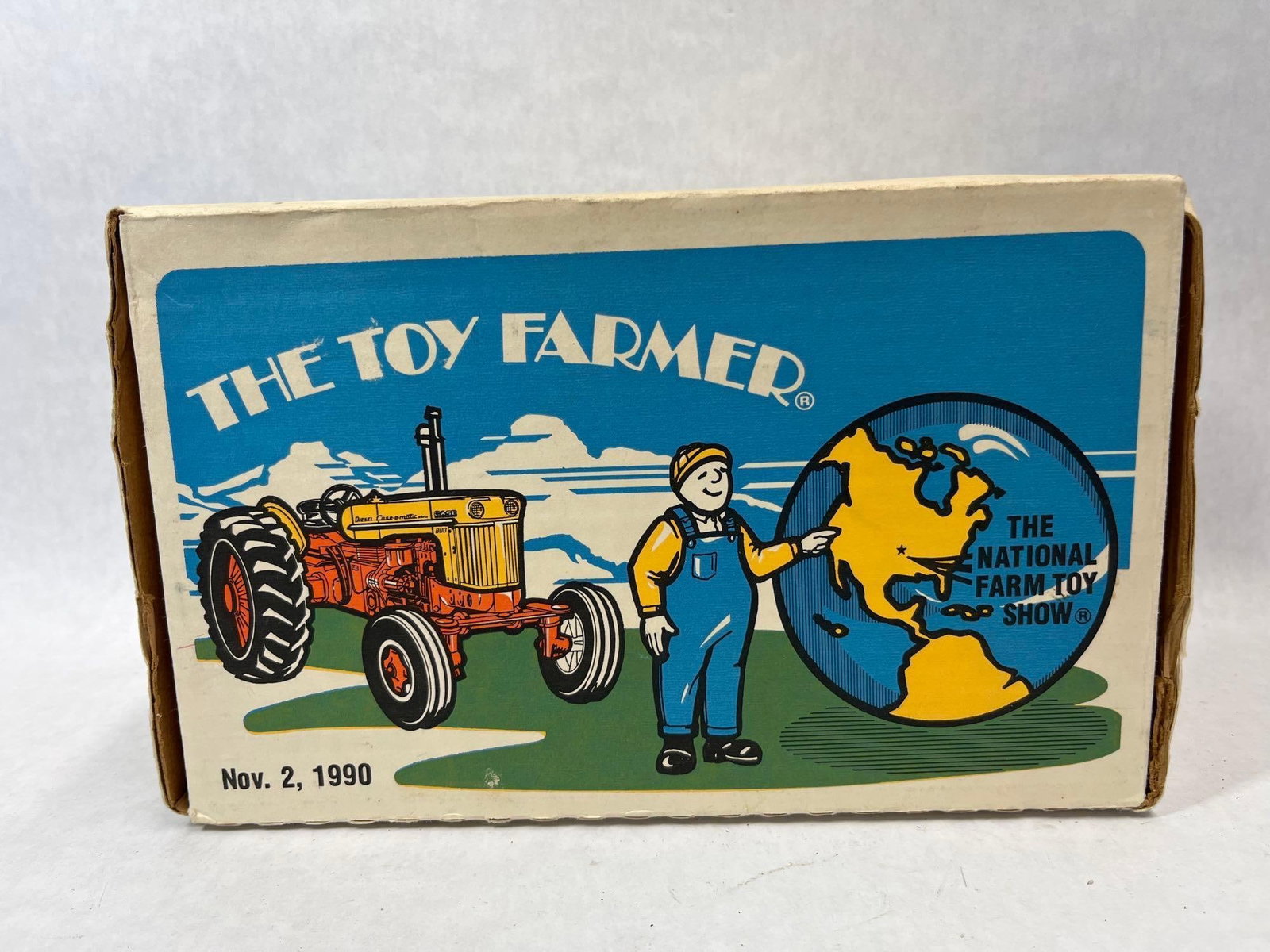 Ertl Toy Farmer 1990 Case 800 Tractor w/ Box: A die-cast metal collector edition toy tractor manufactured by The Ertl Company, Inc. based in Dyersville, Iowa. This model was commissioned by Toy Farmer LTD to commemorate The National Farm Toy Show