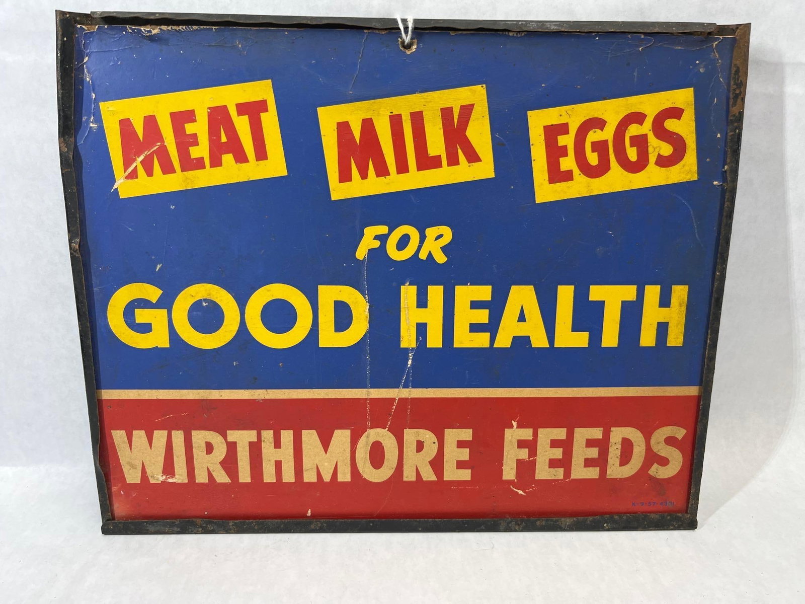 Wirthmore Feeds Lithographed Metal Sign: A lithographed advertising sign for Wirthmore Feeds, an agricultural brand originally based in New England. The sign features a bold graphic layout across three distinct color sections. The upper