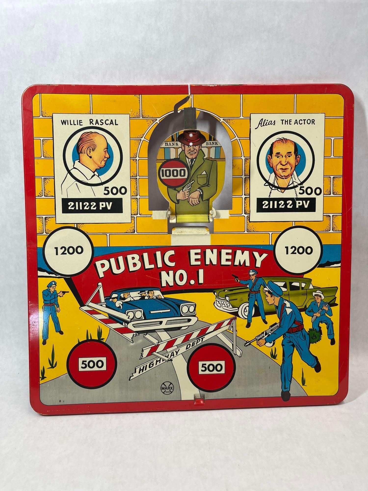 Louis Marx & Co Public Enemy No 1 Tin Target Game: This target game is manufactured by Louis Marx and Co. and titled Public Enemy No. 1. It is constructed from pressed lithographed tin with folded edges. The game features a mid-20th-century crime and