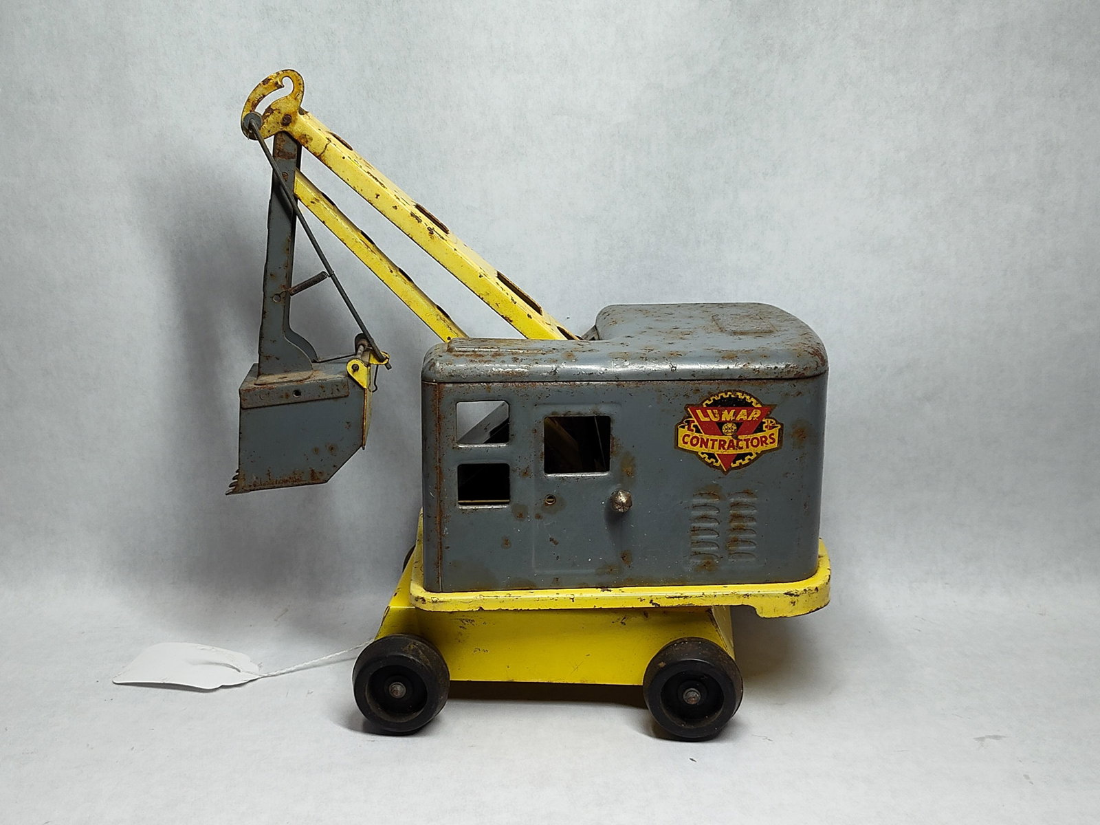 Marx Lumar Contractors Scoop Power Shovel: A pressed steel construction toy manufactured by Louis Marx and Co. under the Lumar Contractors brand. This excavator, styled as a power shovel, is constructed of painted pressed steel with four hard