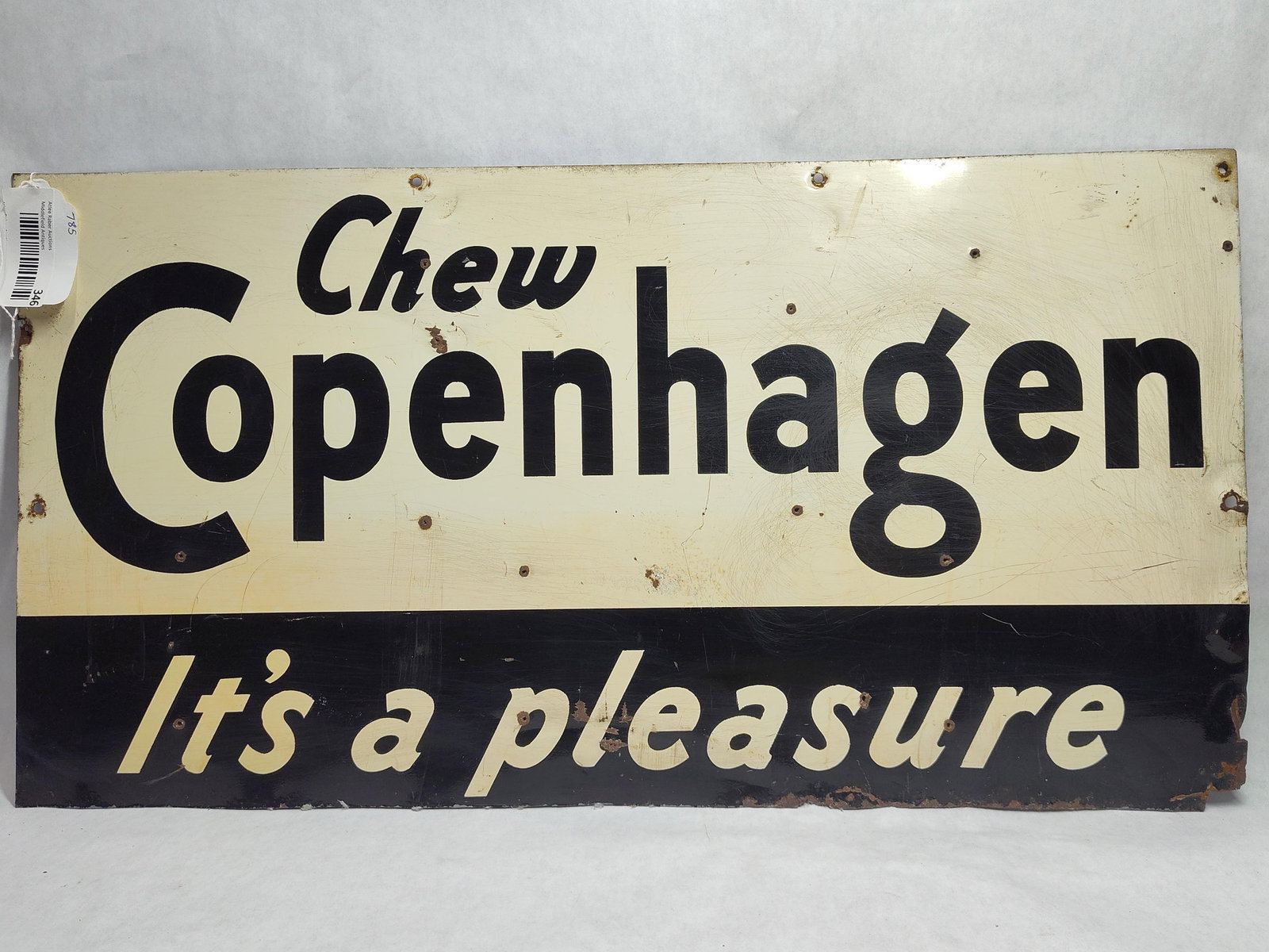 Chew Copenhagen It's a Pleasure Metal Sign: This advertising sign promotes Copenhagen smokeless tobacco and features the brand's classic mid-century design. The rectangular metal sign, likely constructed of painted tin or steel, is divided
