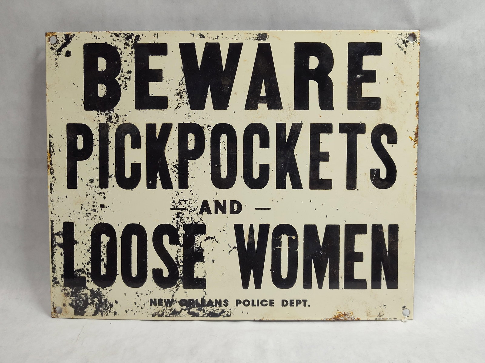 Ande Rooney New Orleans Police Porc. Warning Sign: An Ande Rooney Inc. porcelain enamel reproduction of a New Orleans Police Department warning sign. The sign is constructed from heavy-gauge sheet metal with a white porcelain enamel finish. The front