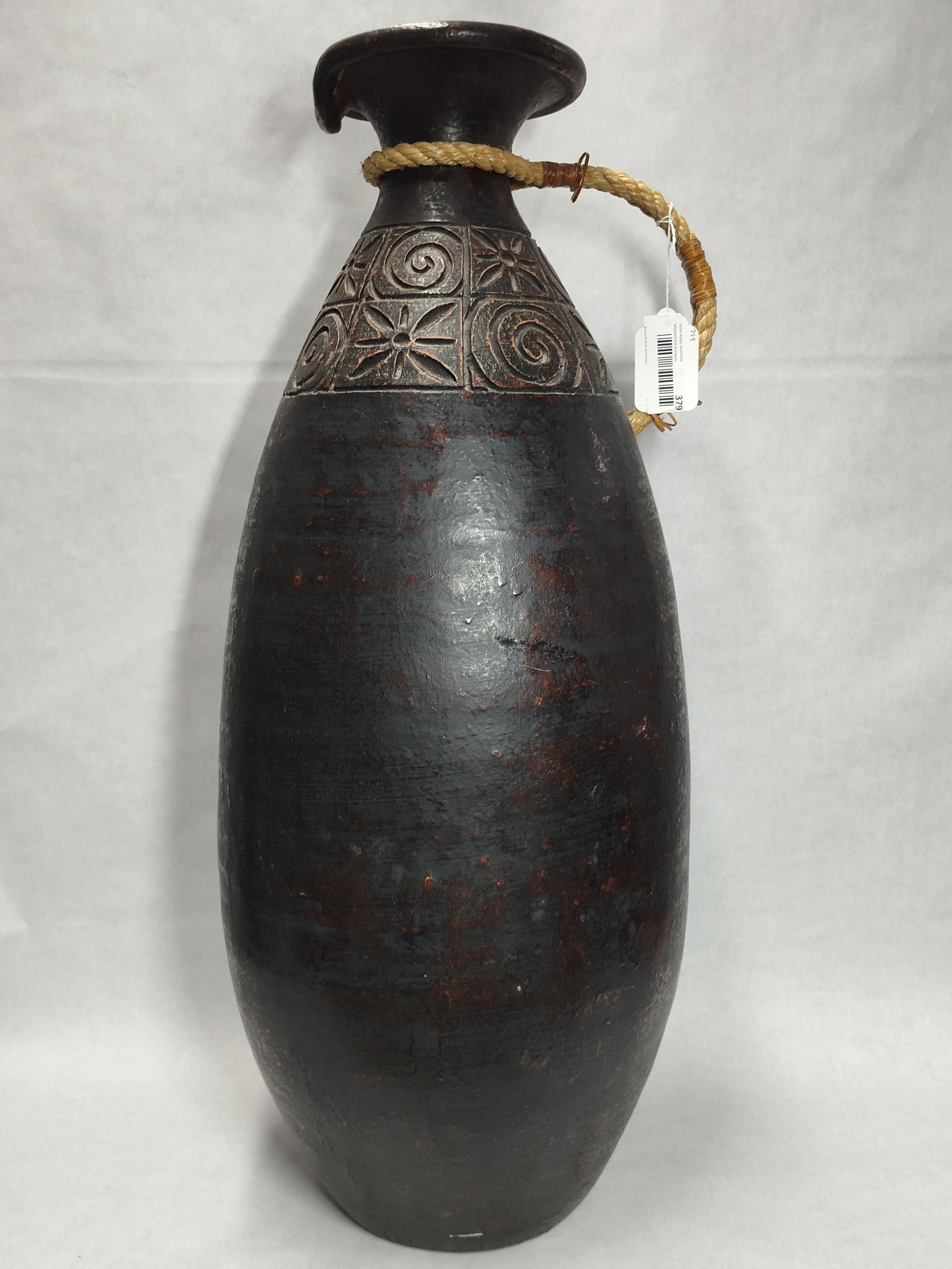 Attr. Arthur Andersson for Wallakra Ceramic Vase: This large, hand-formed ceramic floor vase features a tall, elongated ovoid body with a dark brown to black matte finish, accented by reddish-brown mottling and a textured surface. The shoulder is dec