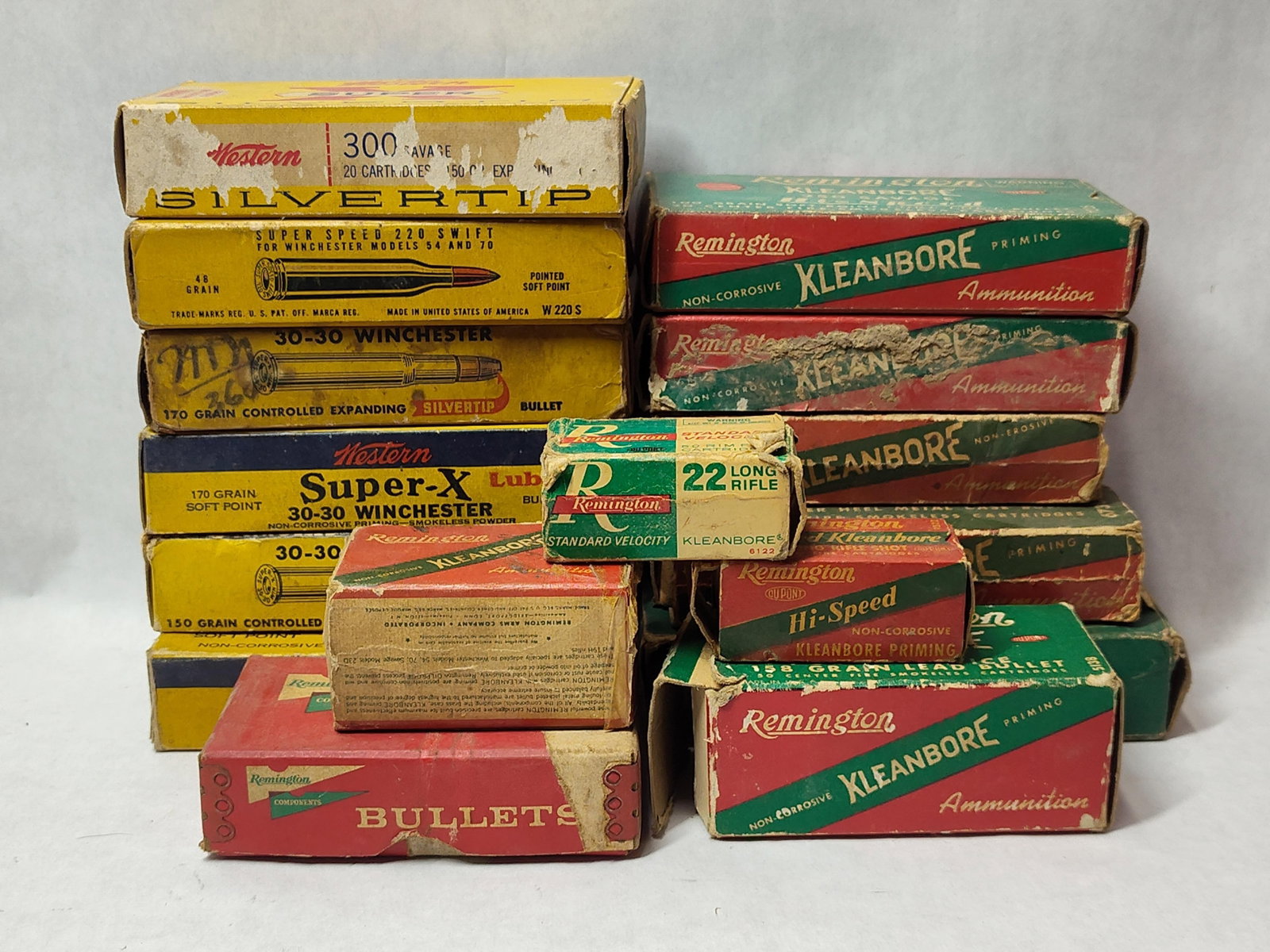 Western, Remington & Winchester Ammunition Boxes: This lot comprises sixteen cardboard ammunition and component boxes from manufacturers Western, Remington, and Winchester. The collection includes a diverse range of calibers and bullet weights: