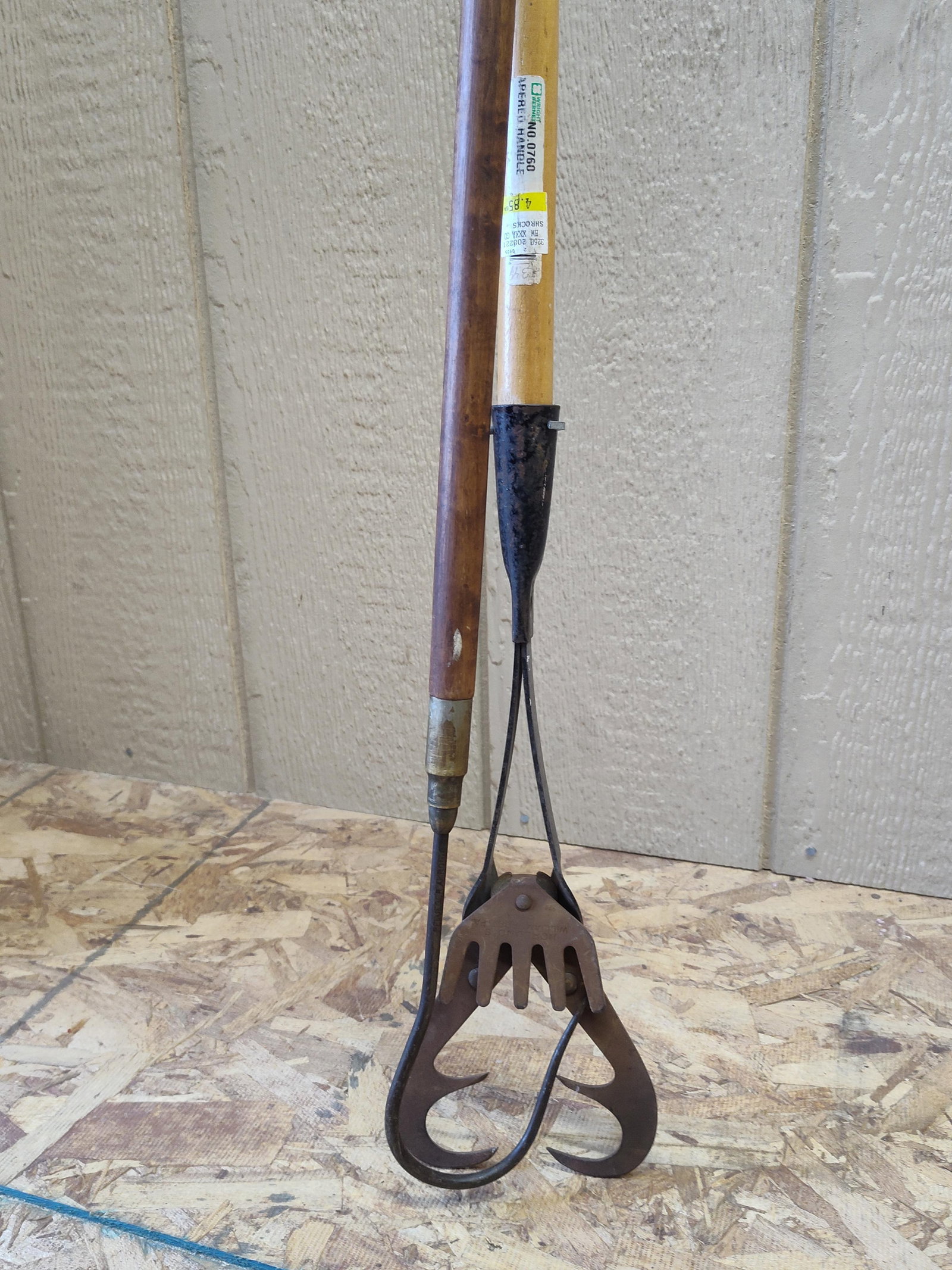 Antique Well Hook & Bucket Retriever: This antique tool is a long-handled well hook or bucket retriever, traditionally used for recovering items dropped into deep wells or shafts. The device features a wrought iron scissor-action mechanis