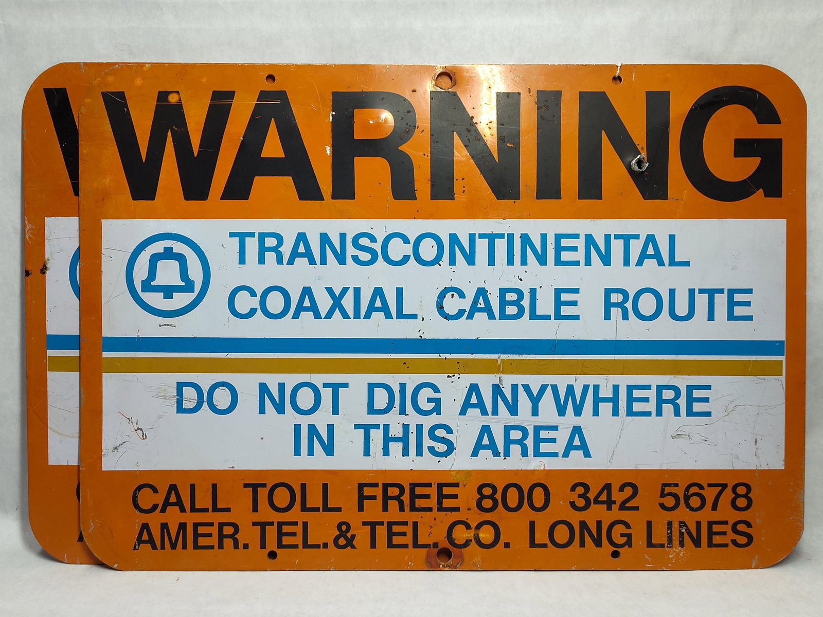 Pair AT&T American Tel & Tel Warning Signs: A pair of industrial utility warning signs produced for the American Telephone and Telegraph Company (AT&T) Long Lines division. These signs are constructed from painted steel and feature a
