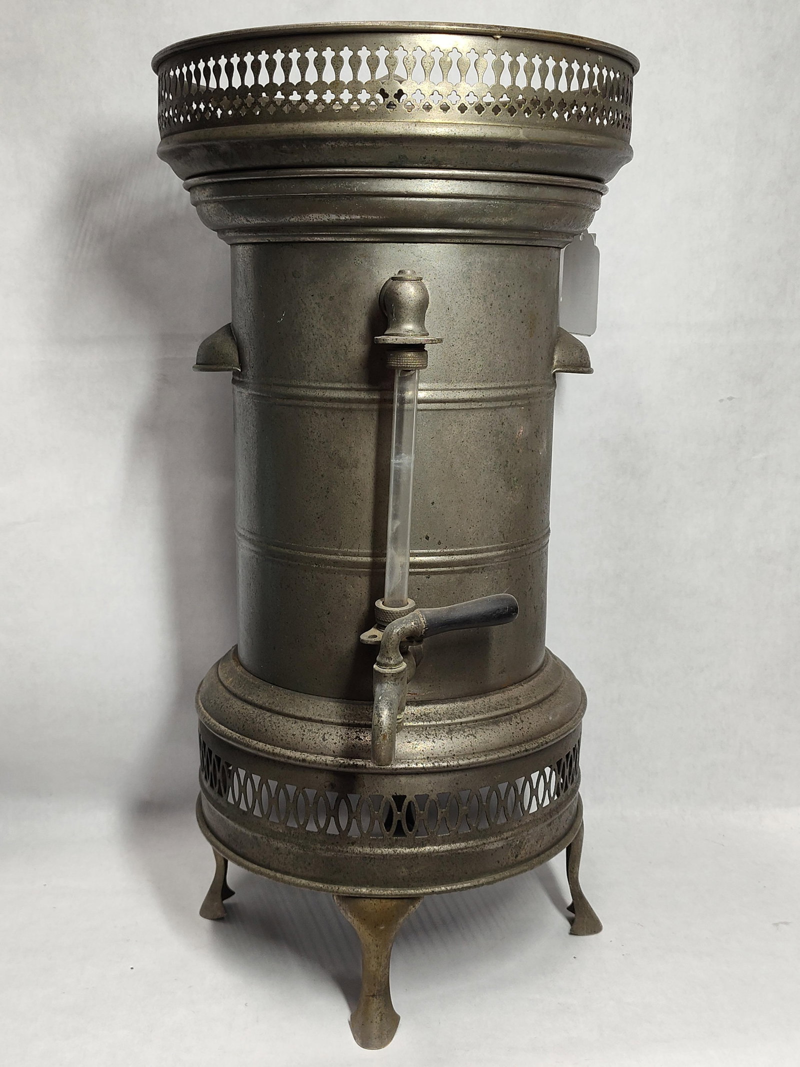 Liquid Carbonic Co. Metal Soda Fountain Dispenser: This large-scale cylindrical vessel is an antique commercial liquid dispenser, likely utilized as a coffee urn or water boiler in a soda fountain environment, and is attributed to the Liquid Carbonic