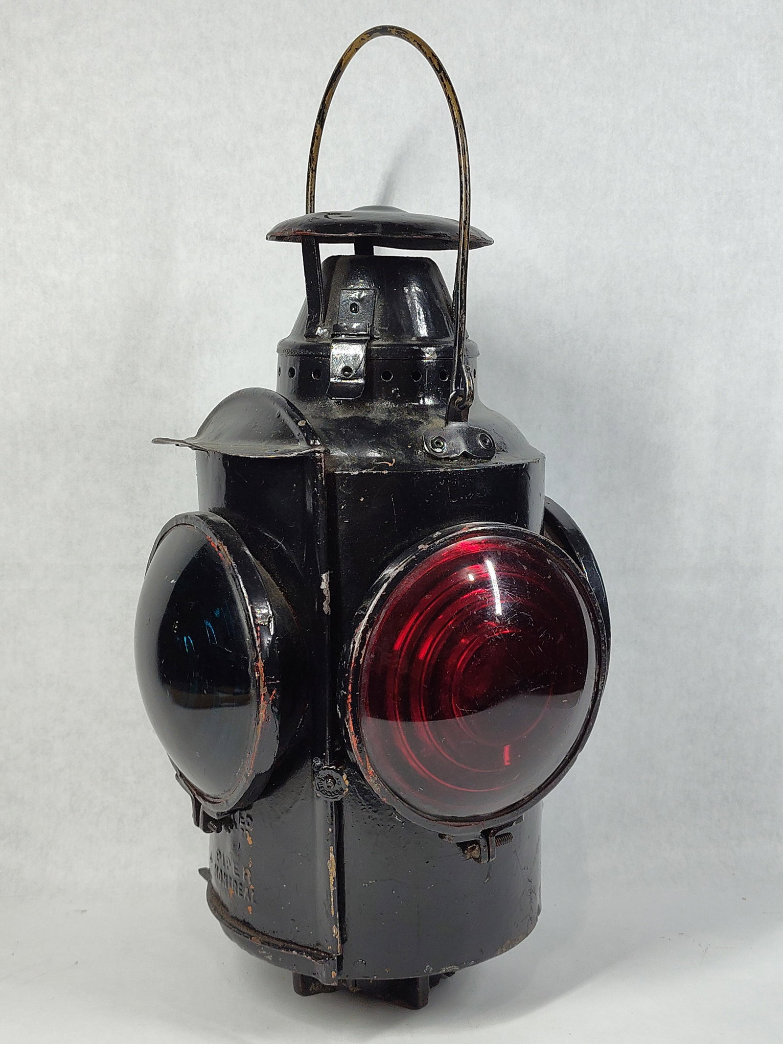 Adlake H. L. Piper Railroad Switch Signal Lantern: An antique four-way railroad switch lamp manufactured by Adams and Westlake (Adlake) for the H. L. Piper Company of Montreal. The lantern features a cylindrical body fabricated from sheet and cast
