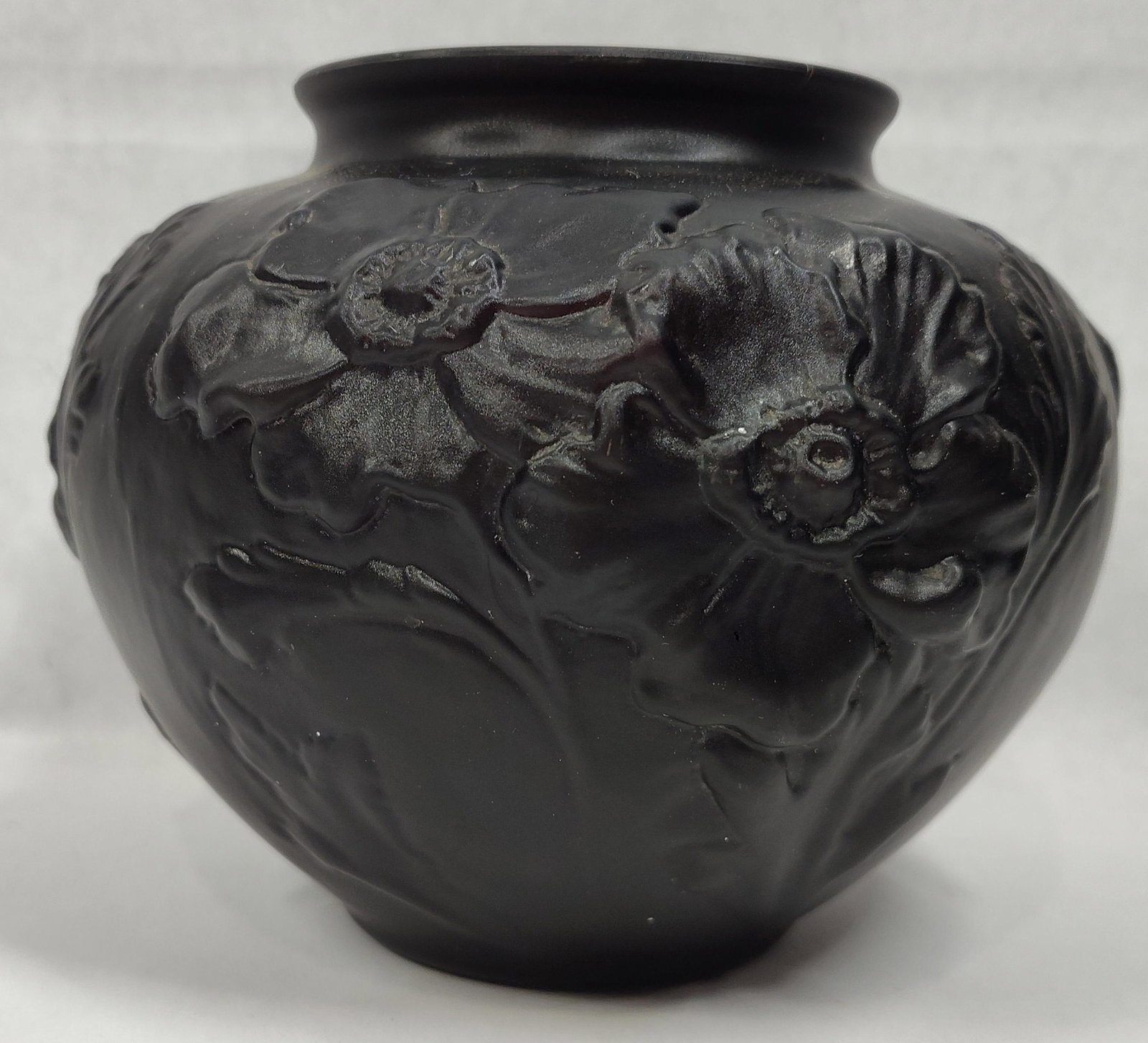 Tiffin Black Amethyst Satin Glass Poppy Vase: A Art Deco period vase attributed to the Tiffin Glass Company of Tiffin, Ohio, featuring the Poppy pattern. The piece is crafted from black amethyst glass, which appears opaque black in reflected