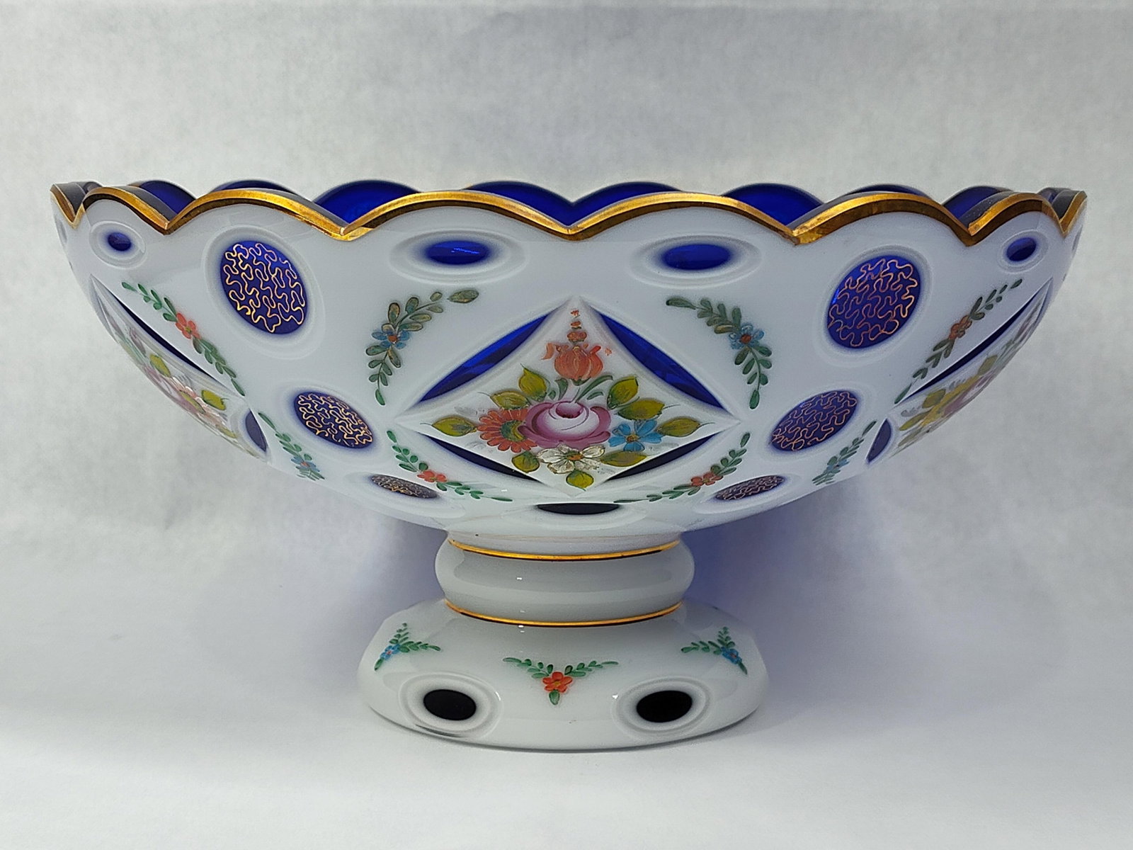 Bohemian Cobalt Blue Overlay Cut Glass Footed Bowl: This large decorative footed centerpiece bowl is a high-quality example of Bohemian art glass from the late 19th or early 20th century, frequently attributed to makers such as Moser or Harrach. The