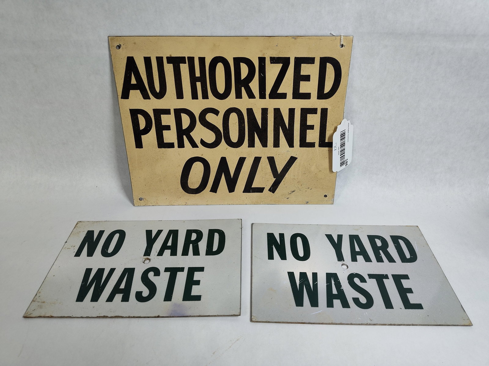 A Trio of Industrial Painted Metal Signs: This lot consists of three industrial-style signs constructed from painted metal. The collection includes one large rectangular sign and a pair of matching smaller utility signs. The large sign is