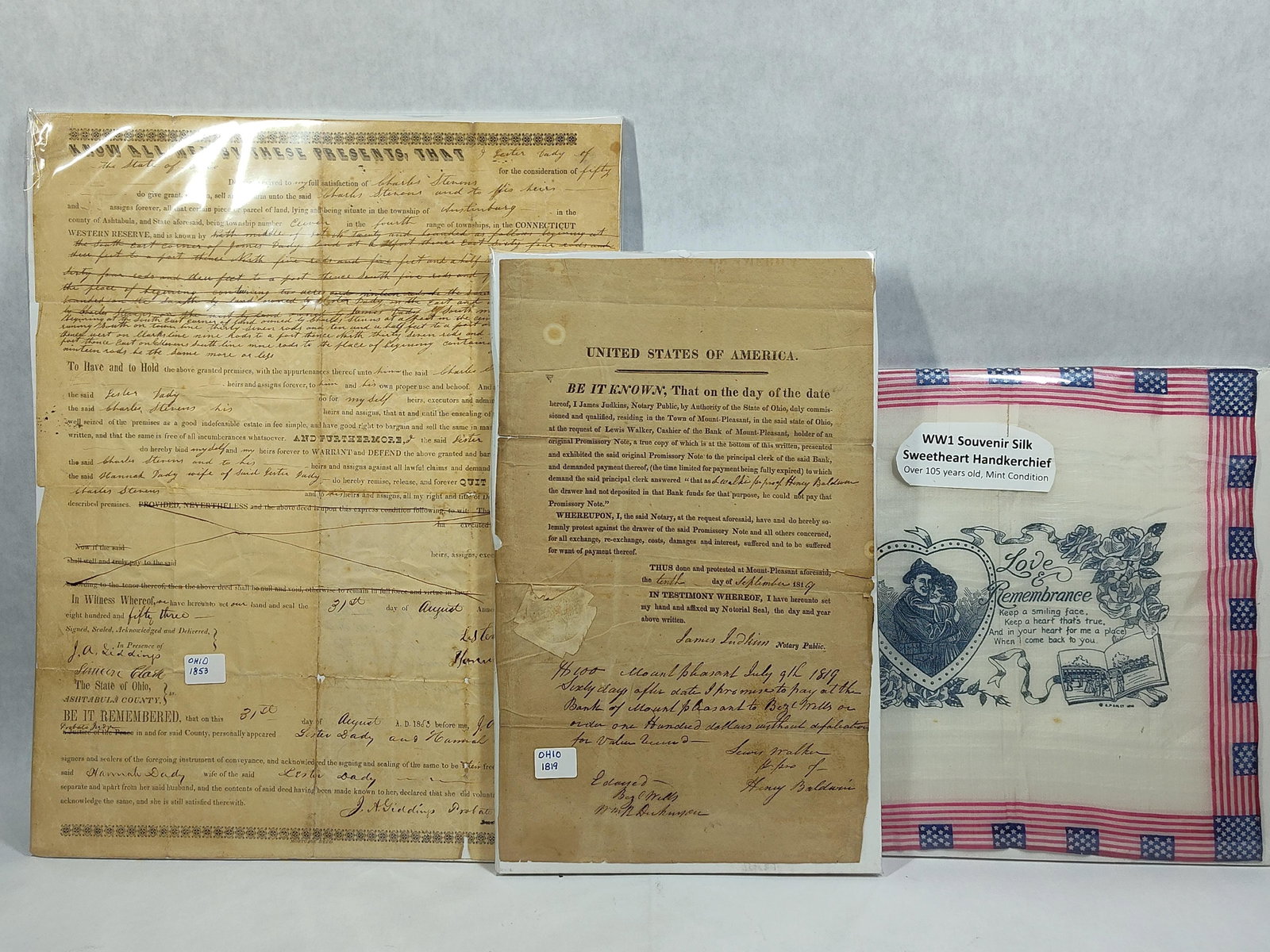 Ohio Documents w/ Giddings & WWI Silk Handkerchief: A trio of historical artifacts consisting of two nineteenth-century Ohio legal manuscripts and a World War I-era textile souvenir. The first item is a handwritten real estate deed from Ashtabula
