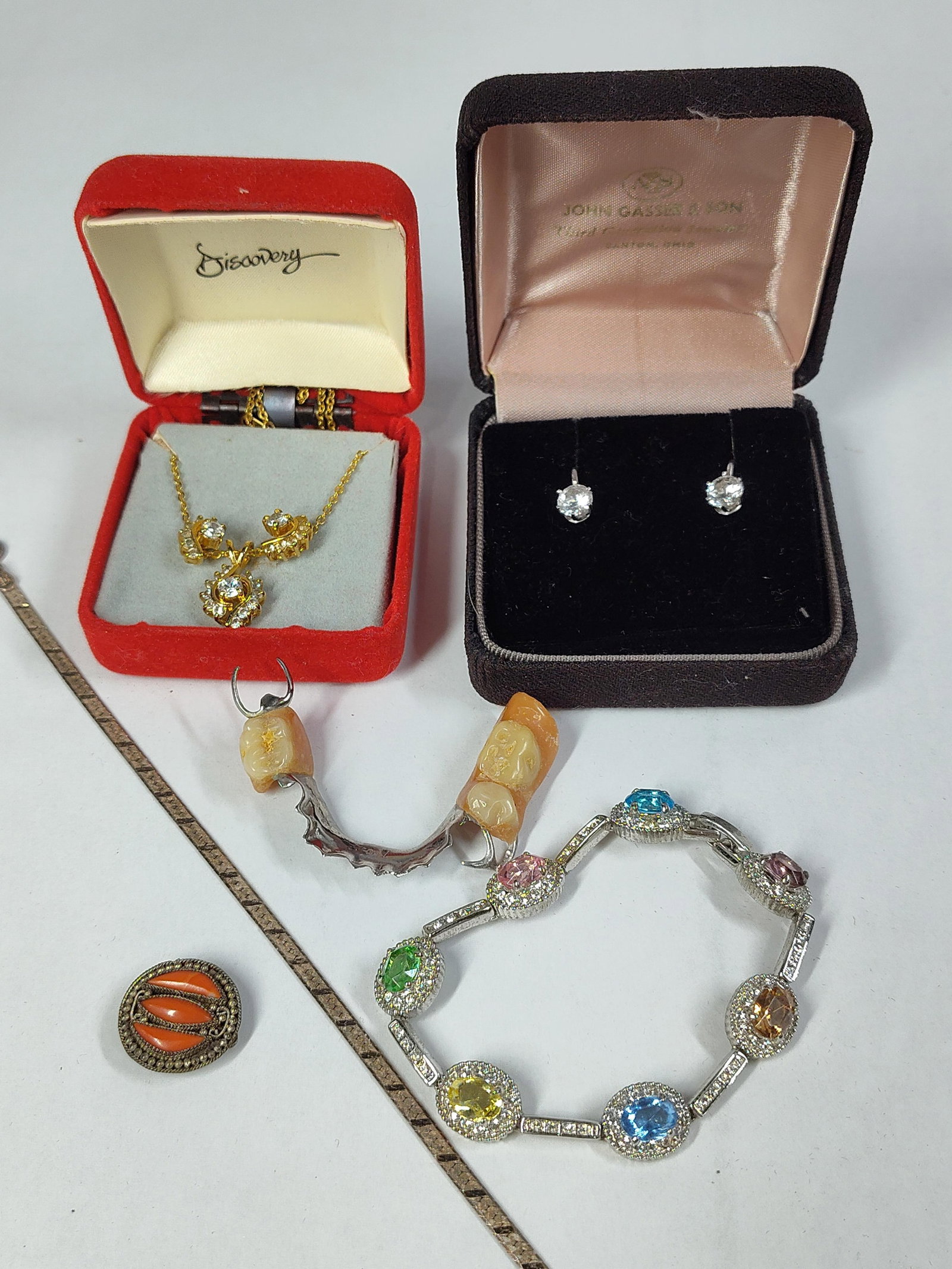 Costume Jewelry, Str. Chain & Dental Prosthetic: This group comprises several items of jewelry and a personal medical appliance. Included is a sterling silver herringbone chain featuring a flat, flexible design and a lobster claw clasp. It is